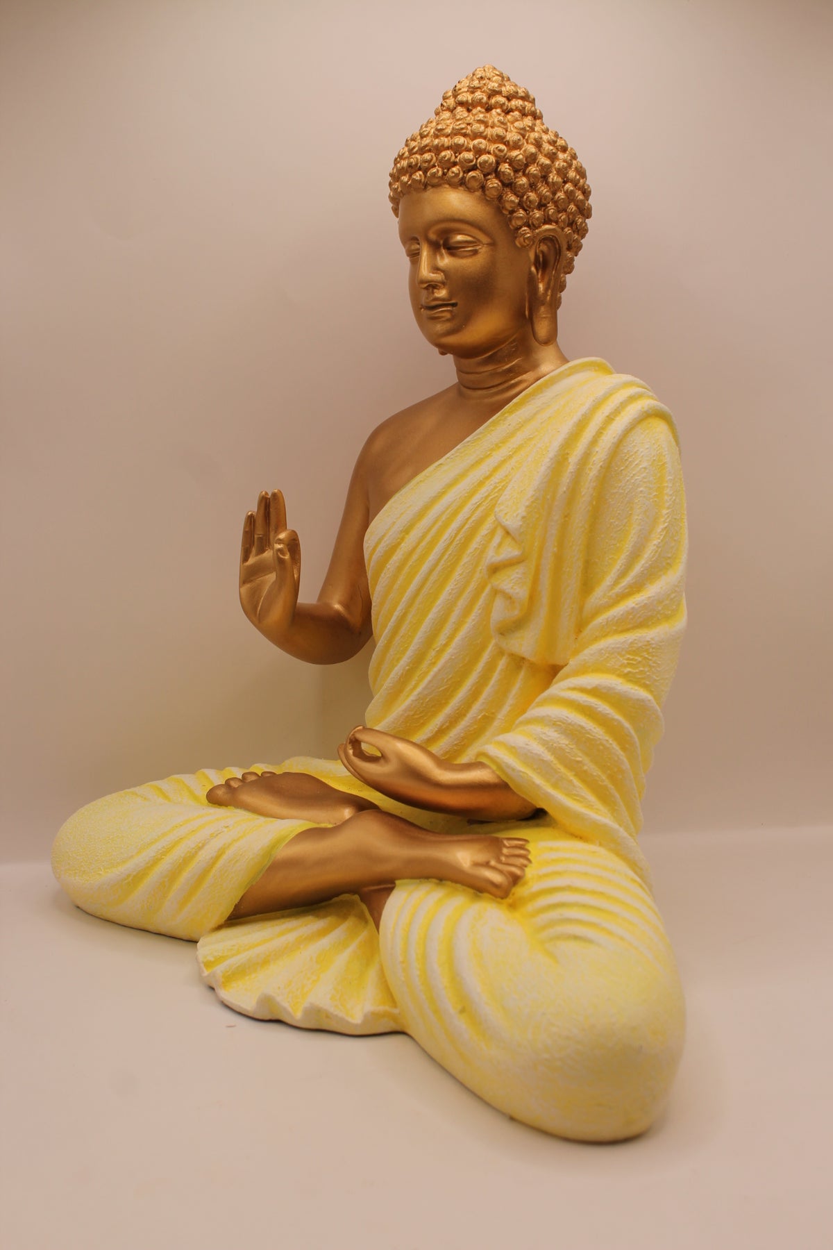 Pastel yellow Buddha statue, right side