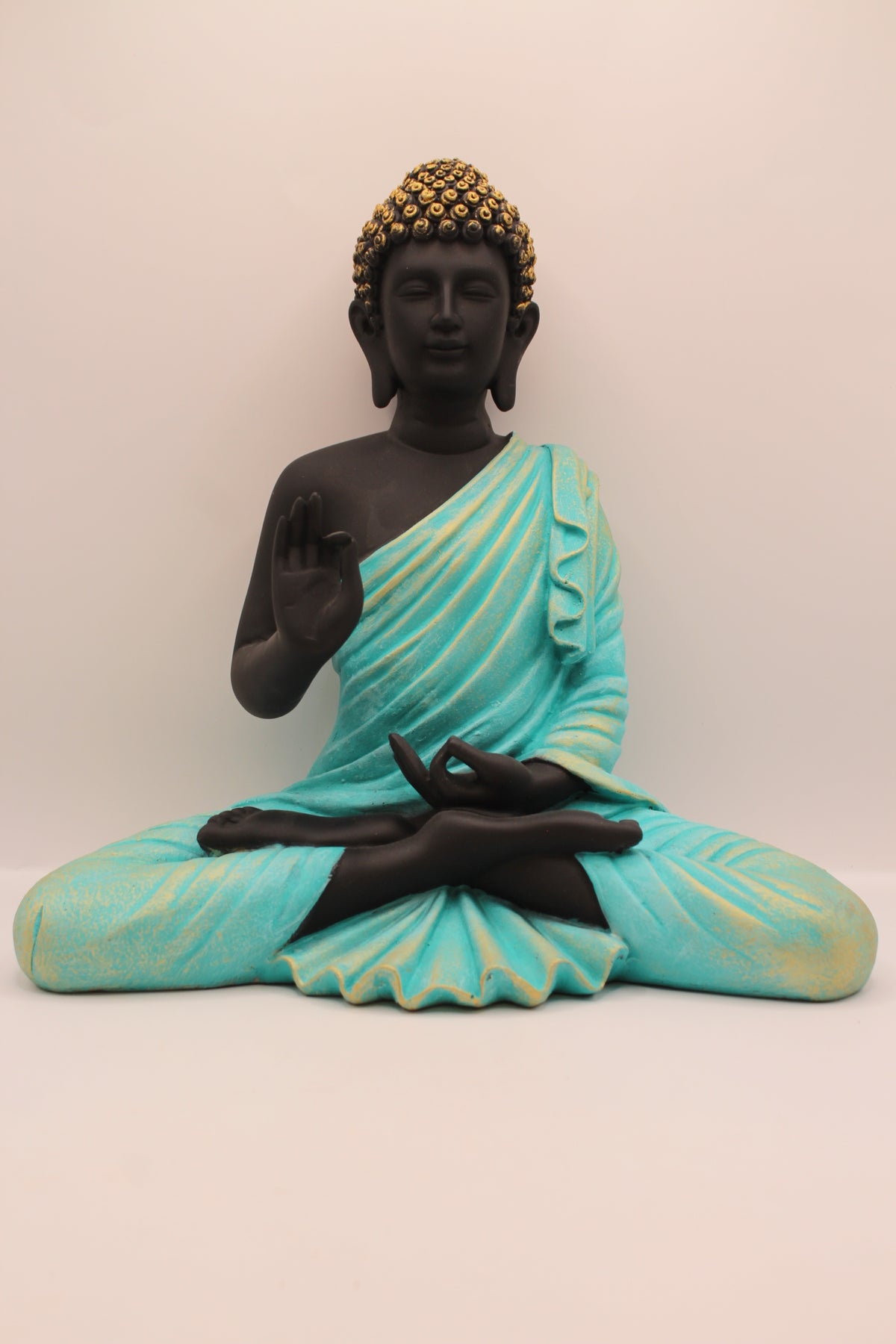 Resin Buddha statue with sea blue robe and black body, front