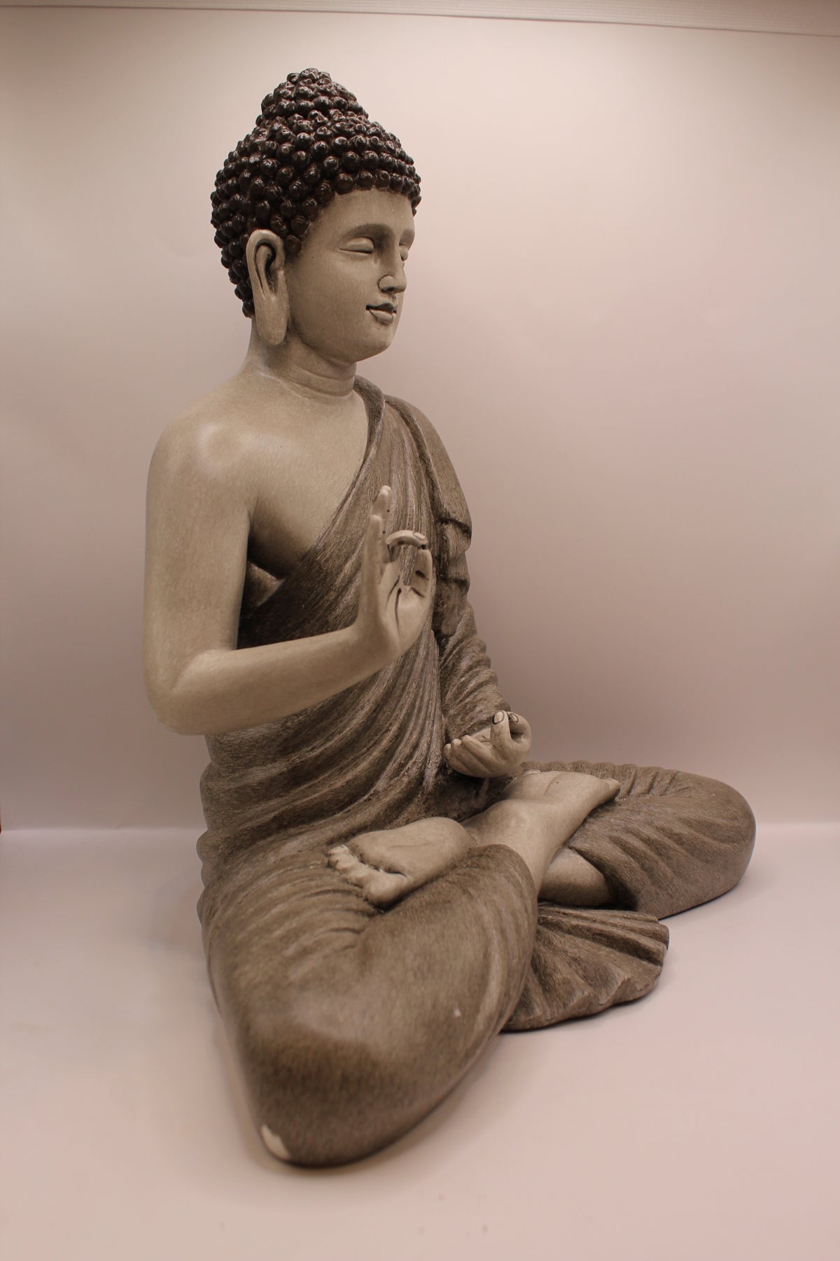 Slate grey Buddha statue, left side