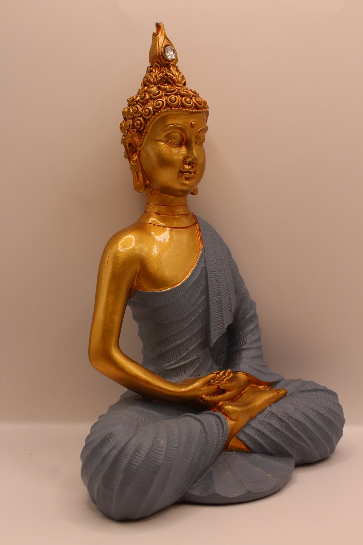 Slate grey meditating Buddha statue, left side