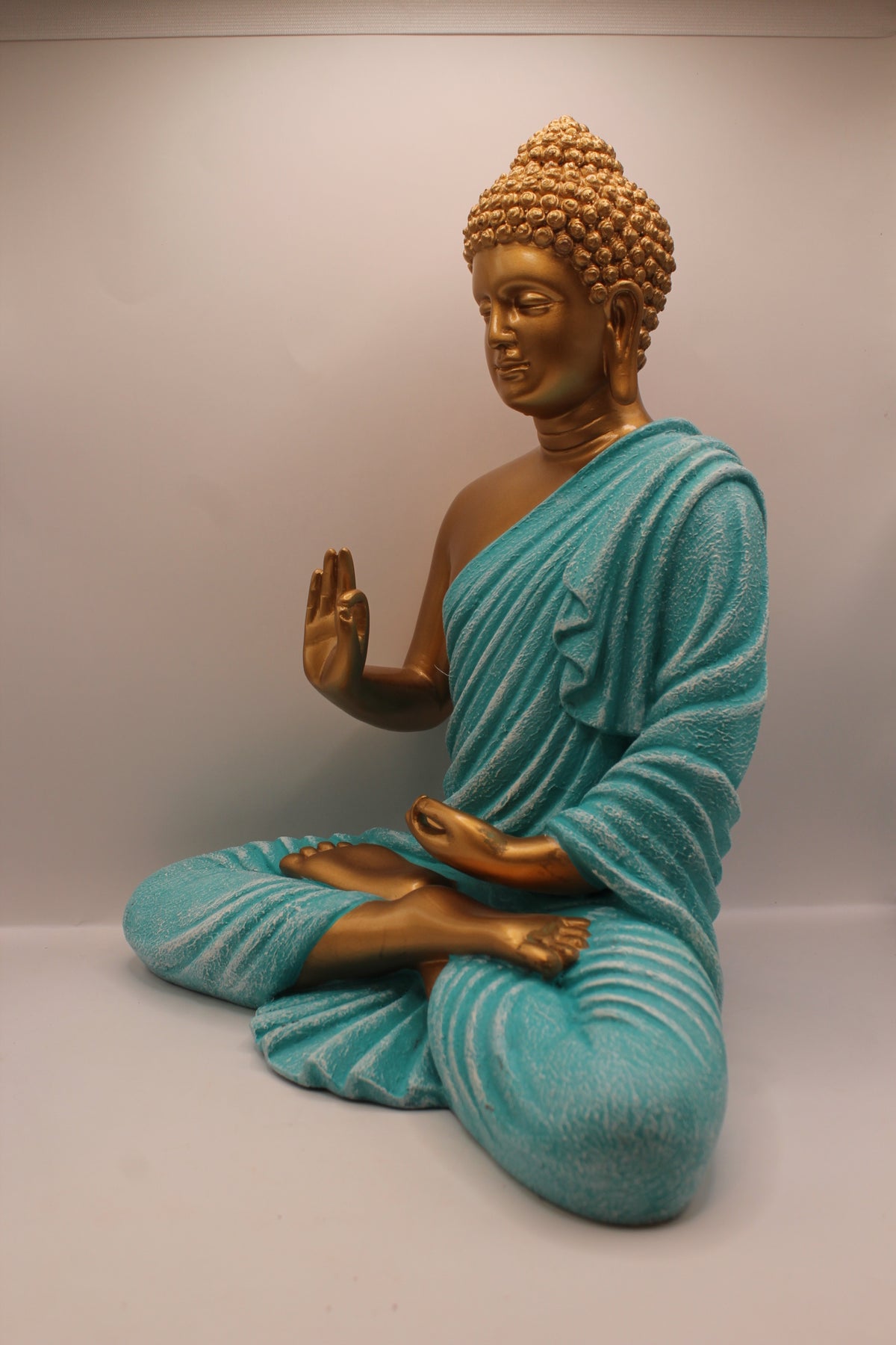 Turquoise and gold Buddha statue, right side
