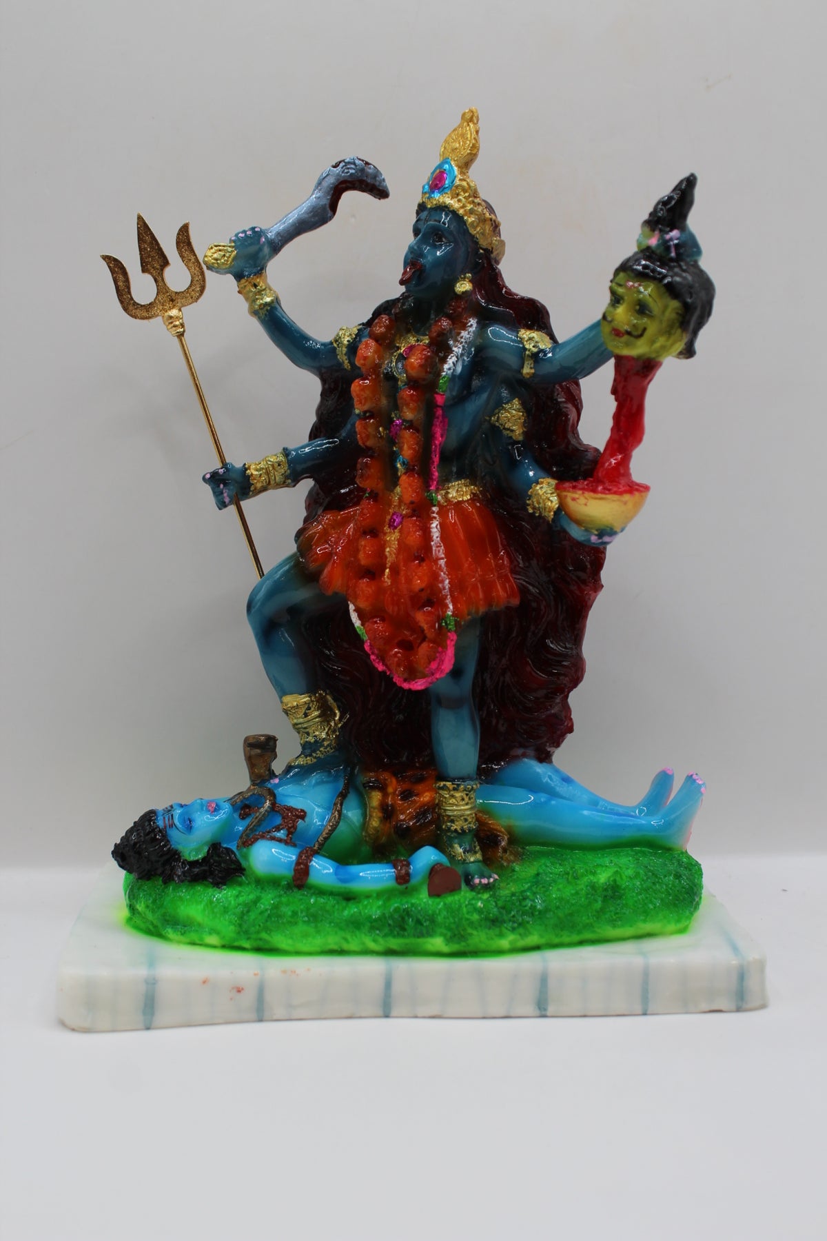 Resin Kali Mata statue, blue kali on green base, front view
