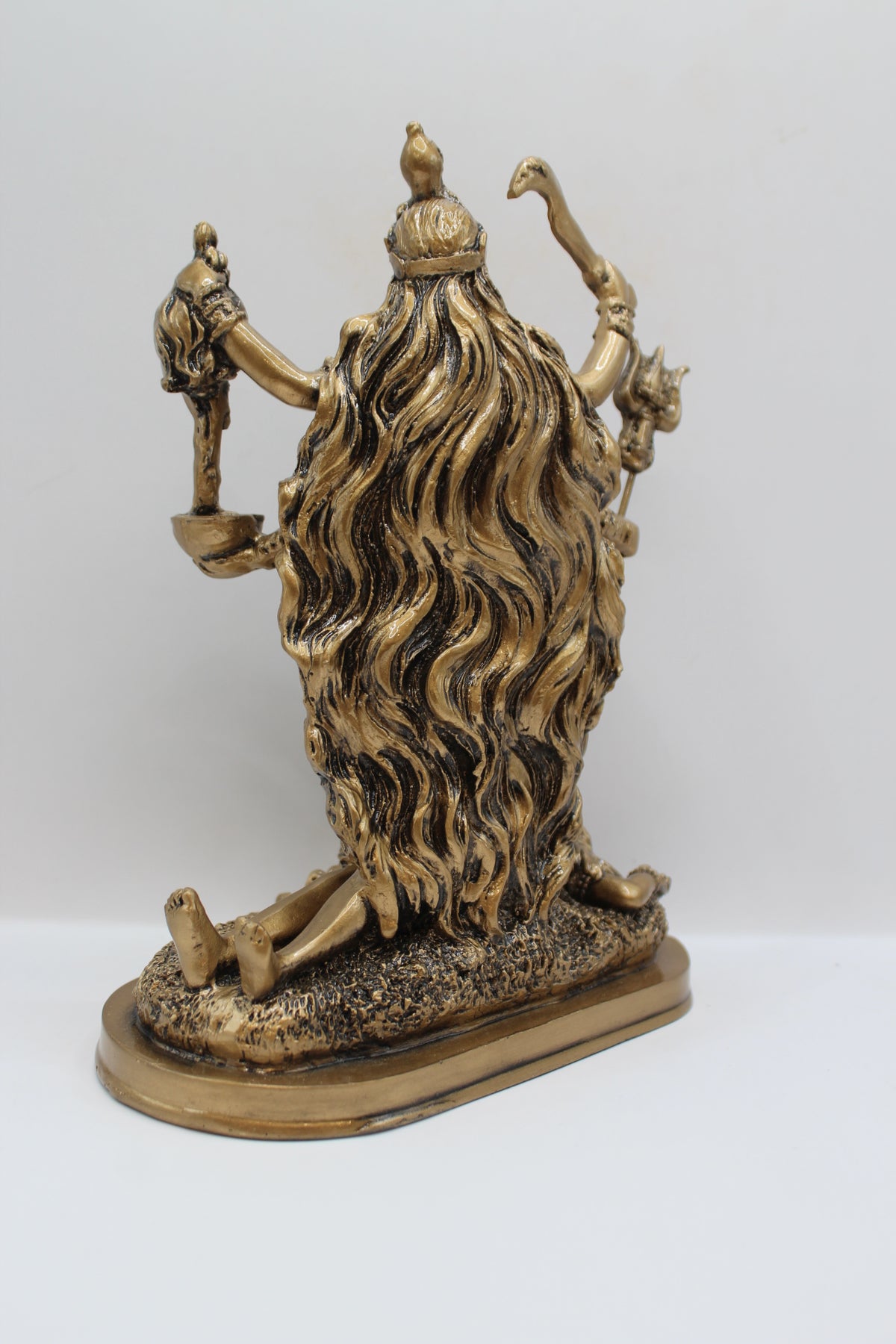 Resin Kali Mata statue, golden finish, back view