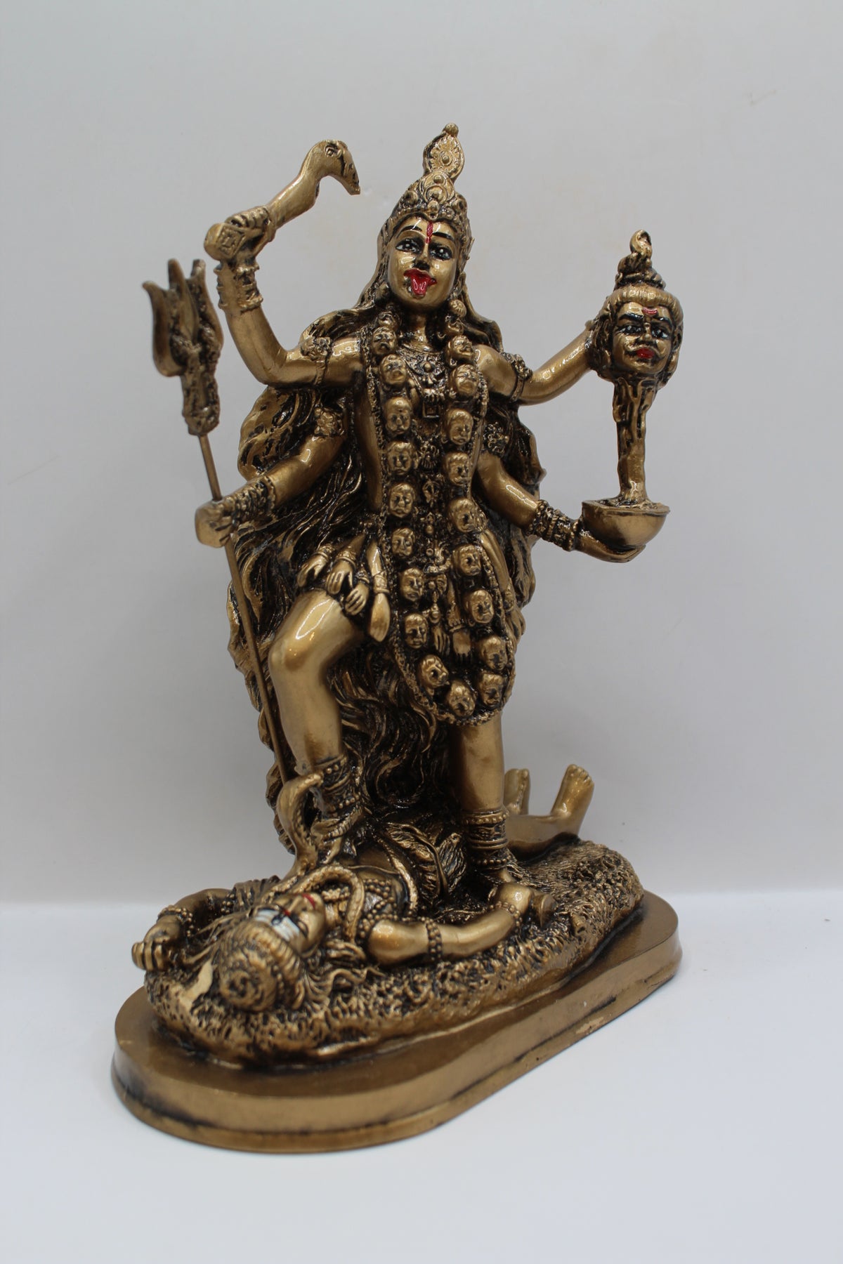 Resin Kali Mata statue, golden finish, left side view