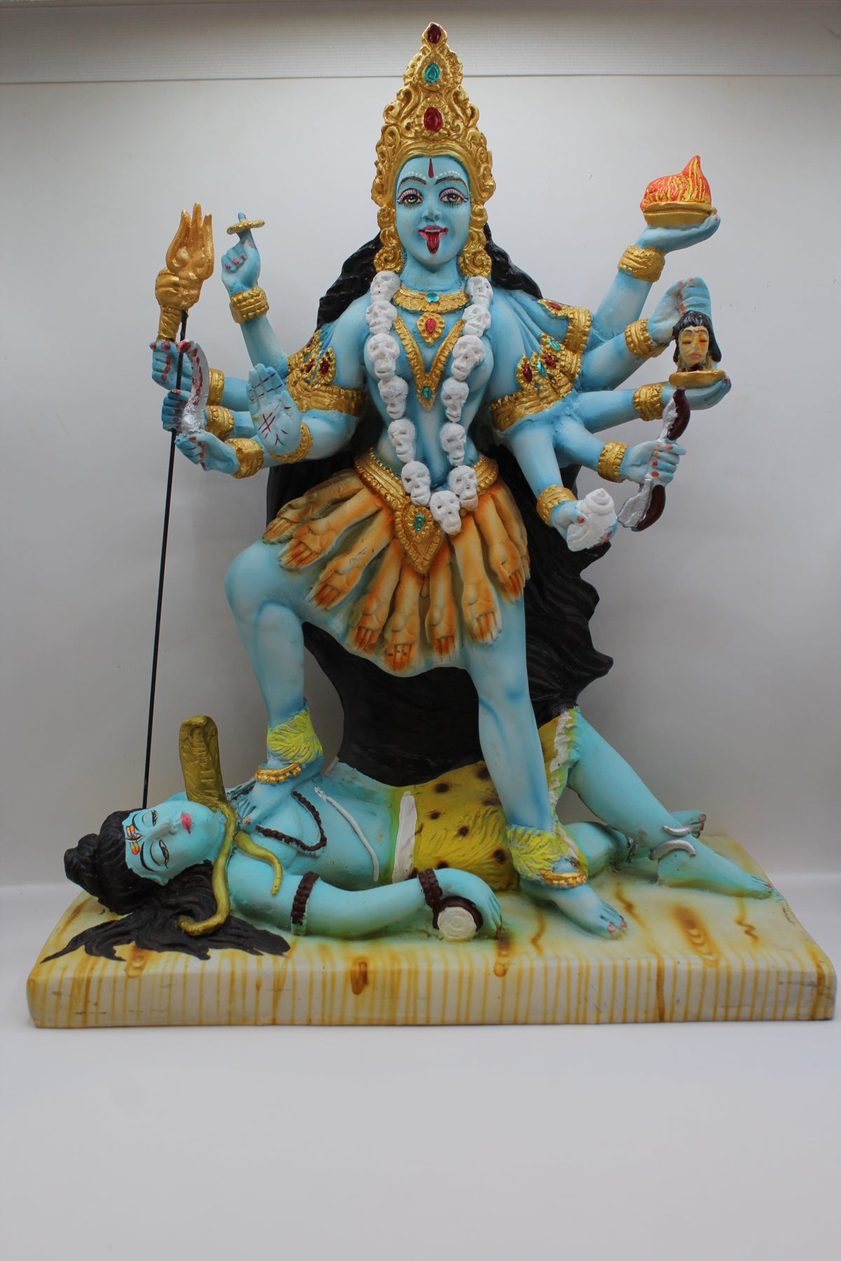 Resin Kali Mata statue, many arms, blue and gold, front view