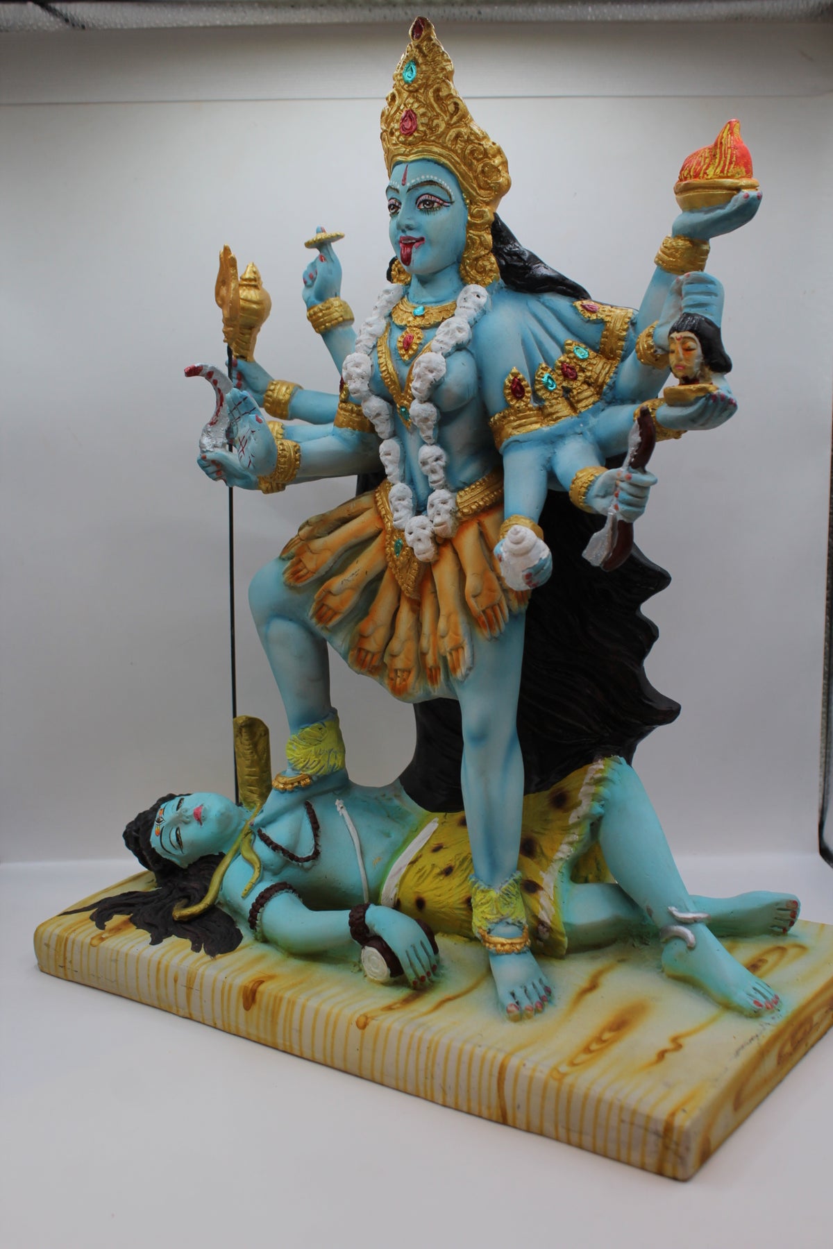 Resin Kali Mata statue, many arms, blue and gold, right side view