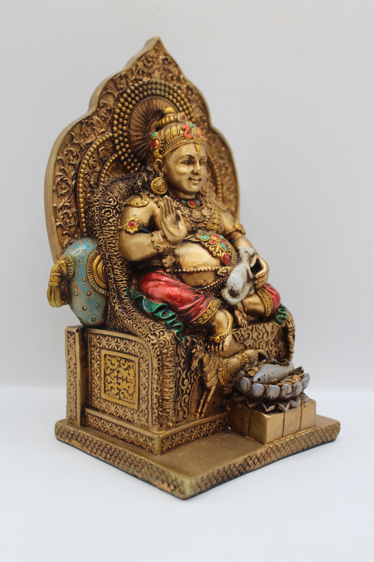 Resin Kuber statue, seated on throne, antique bronze, left side view