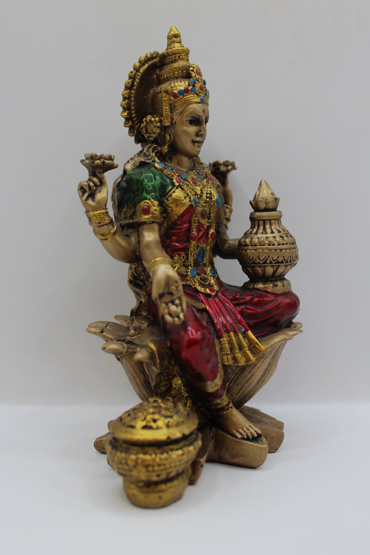 Resin Laxmi statue, seated on lotus, antique bronze, left side view