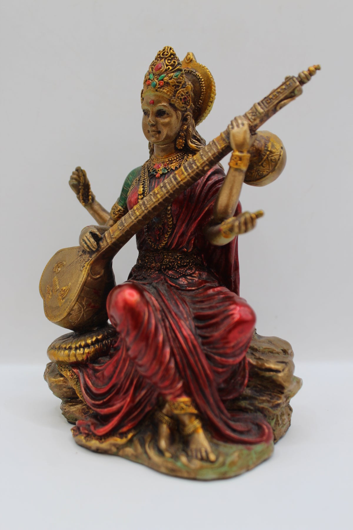 Resin Saraswati statue, playing veena, antique bronze, right side view