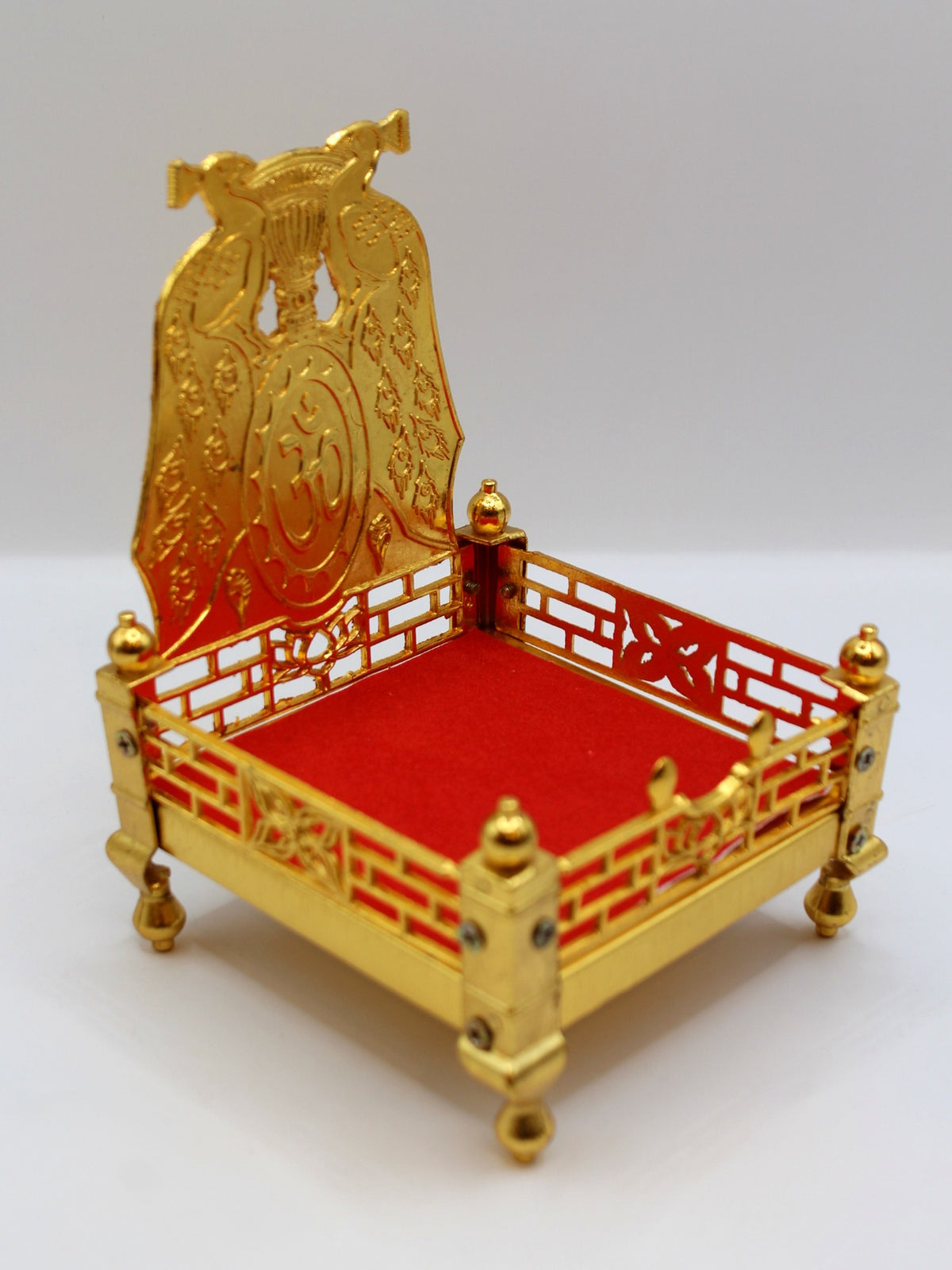Gold metal sinhasan with red velvet seat, 10 x 10 x 15, angled view