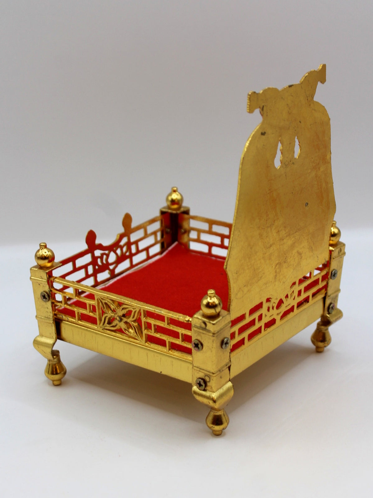 Gold metal sinhasan, 10 x 10 x 15, showing jaali sides and velvet seat