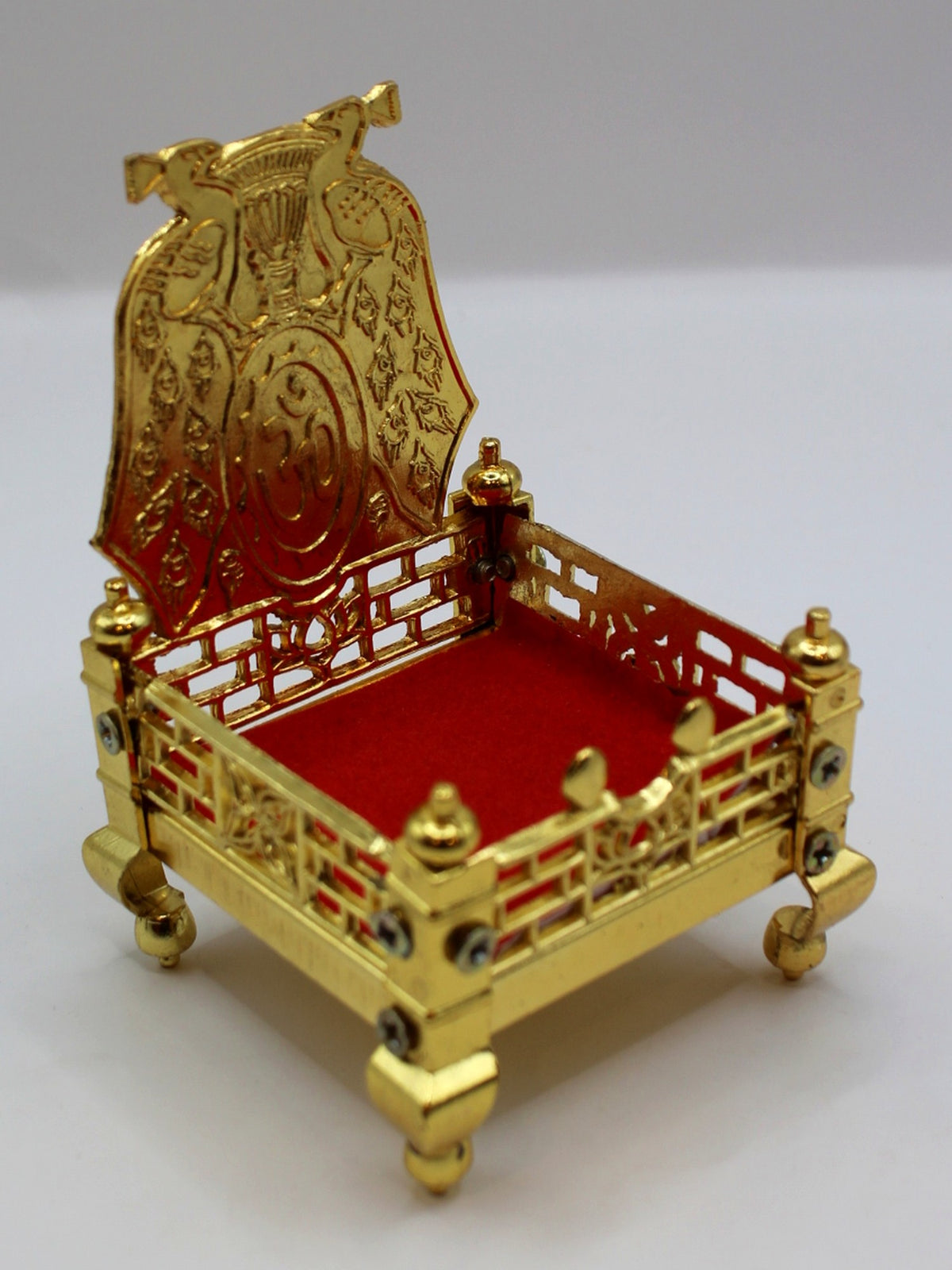 Gold metal sinhasan with red velvet seat, 6 x 6 x 10, angled view