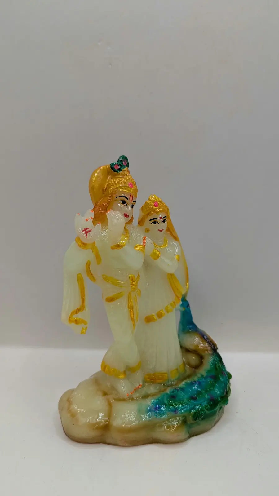 White and multicolour Radha Krishna statue, side view