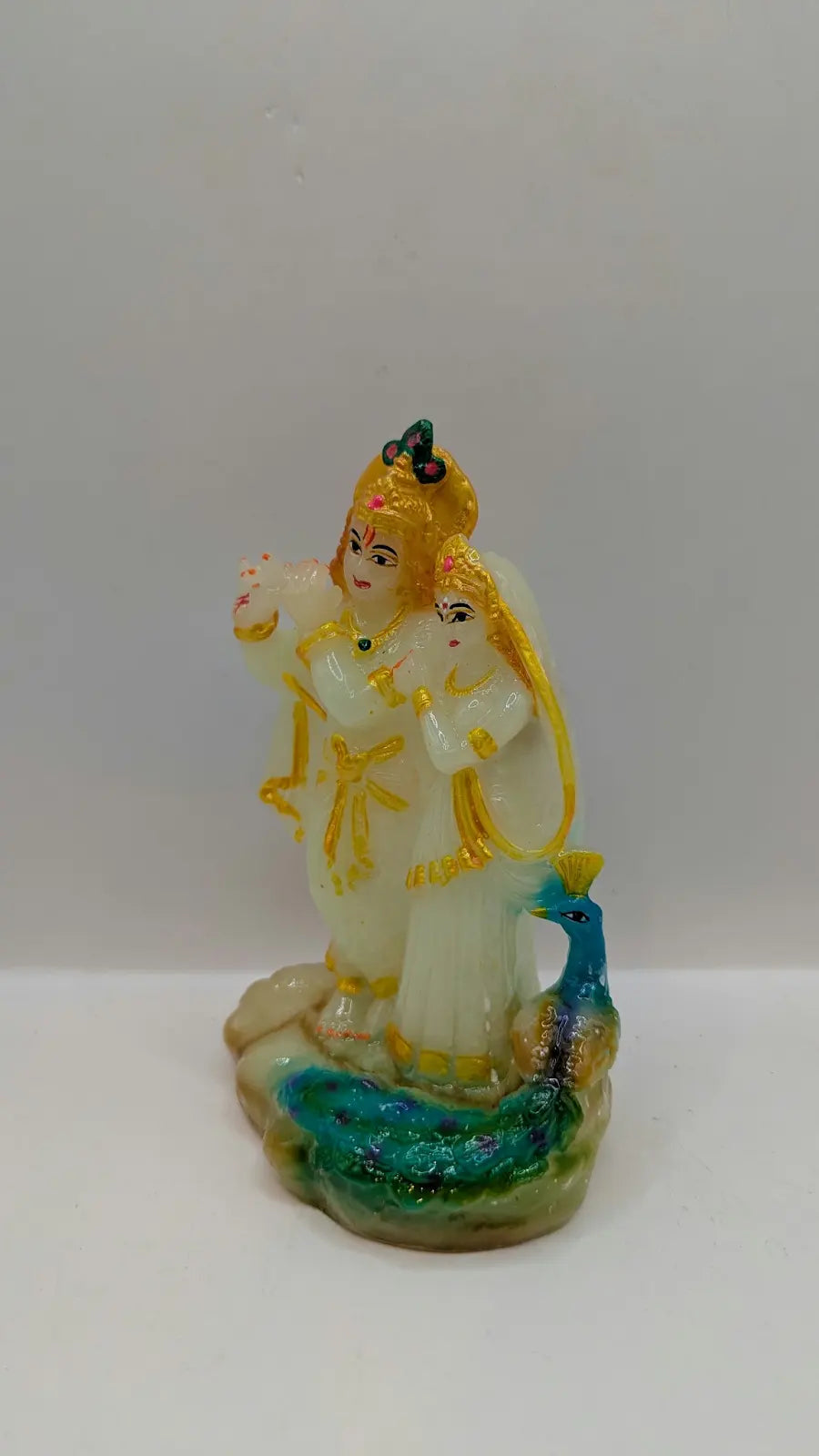 White and multicolour Radha Krishna statue, other side view