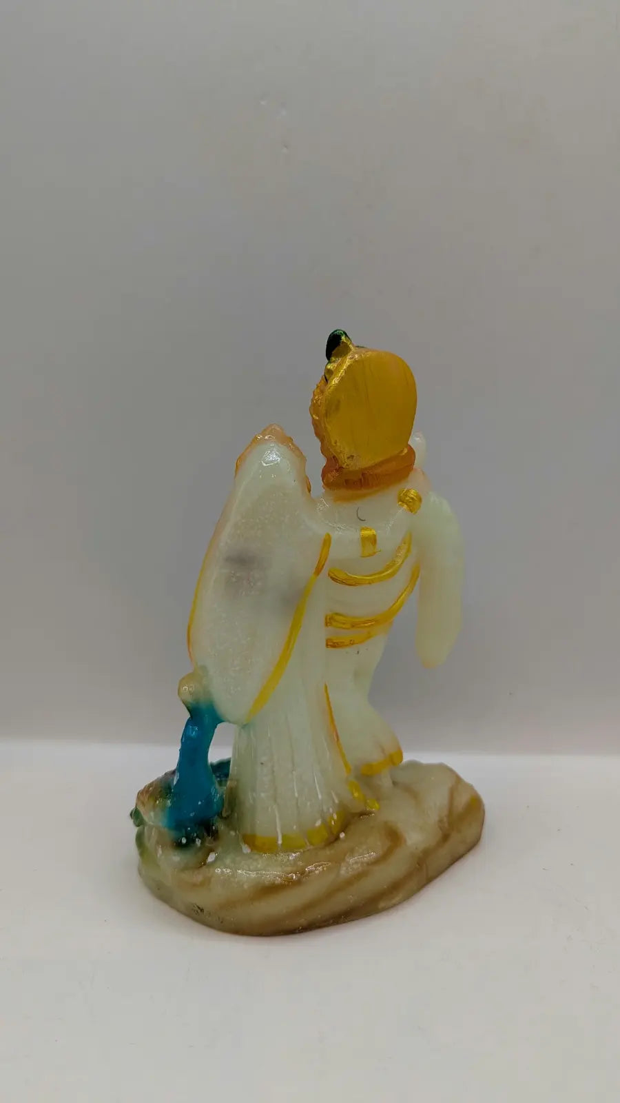 White and multicolour Radha Krishna statue, back view