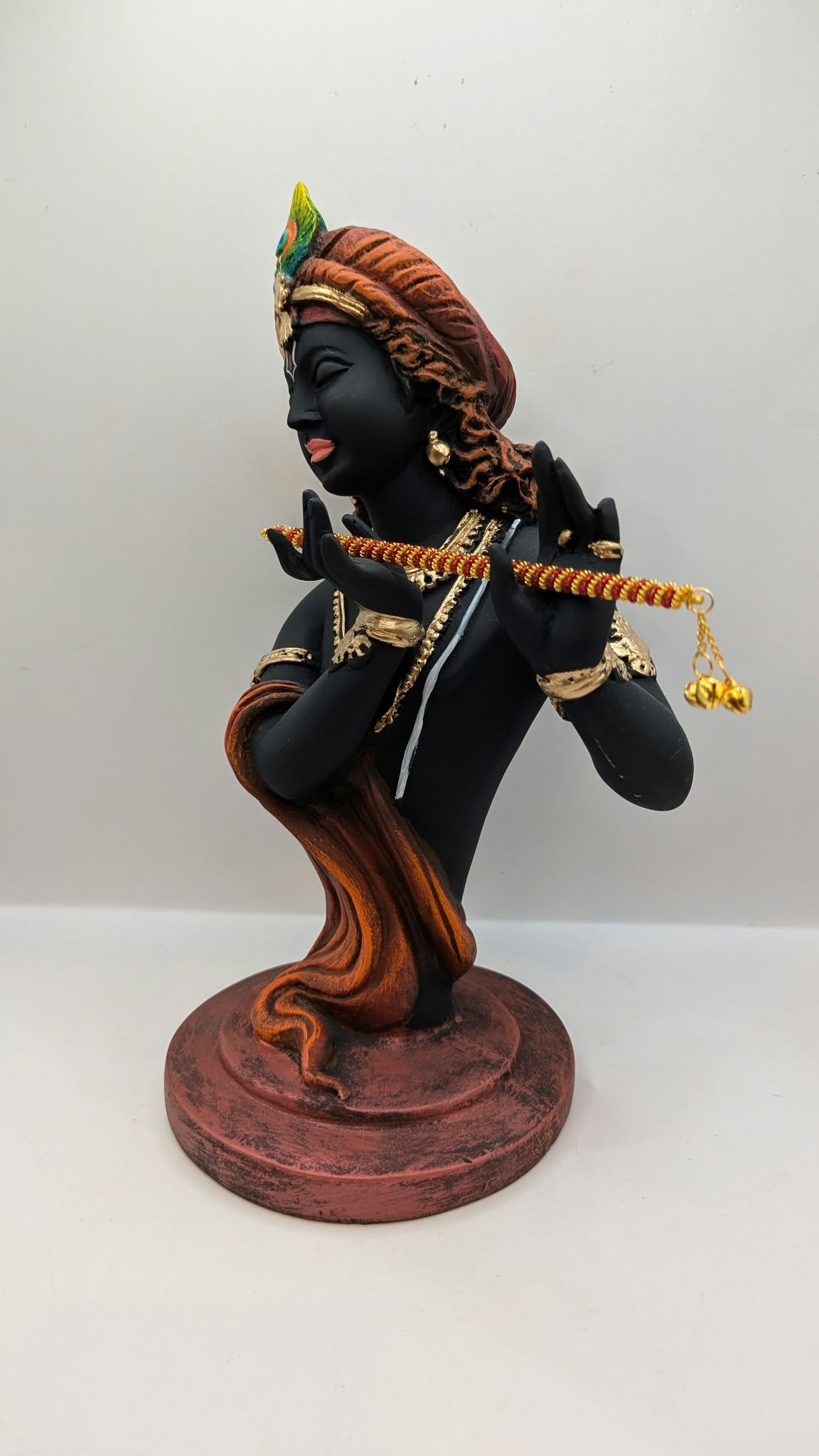 Black Lord Krishna bust statue with flute, side view