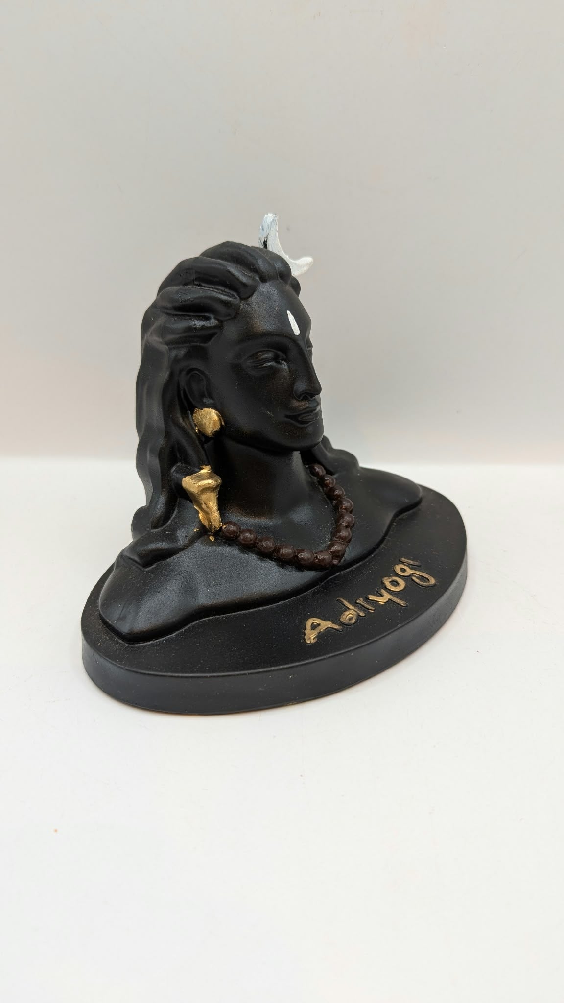 Black Adiyogi Shiva statue, side view from the right