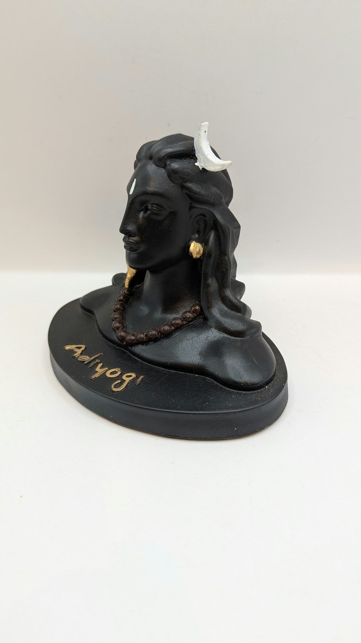 Black Adiyogi Shiva statue, side view from the left