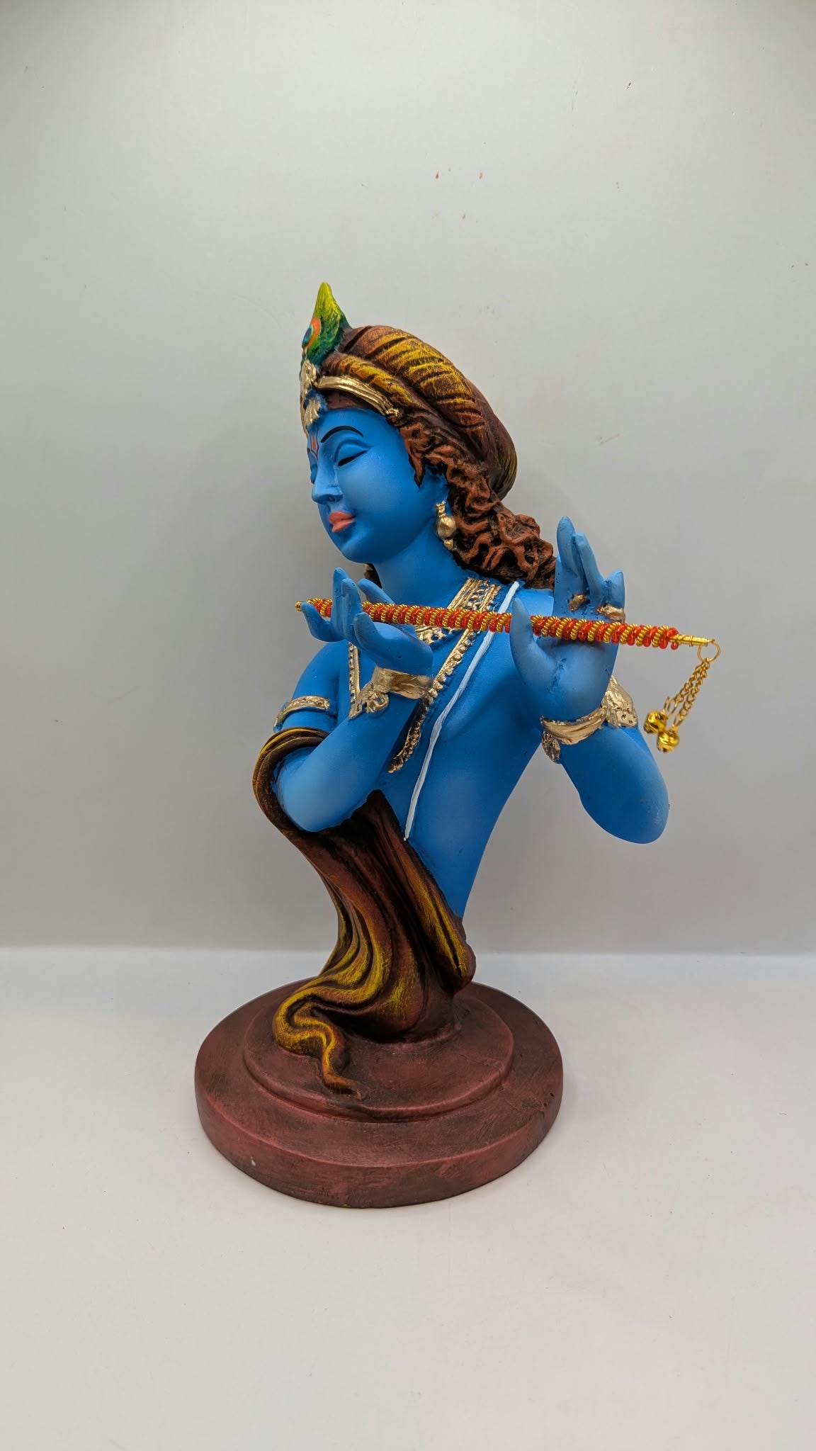 Blue Lord Krishna bust statue with flute, side view
