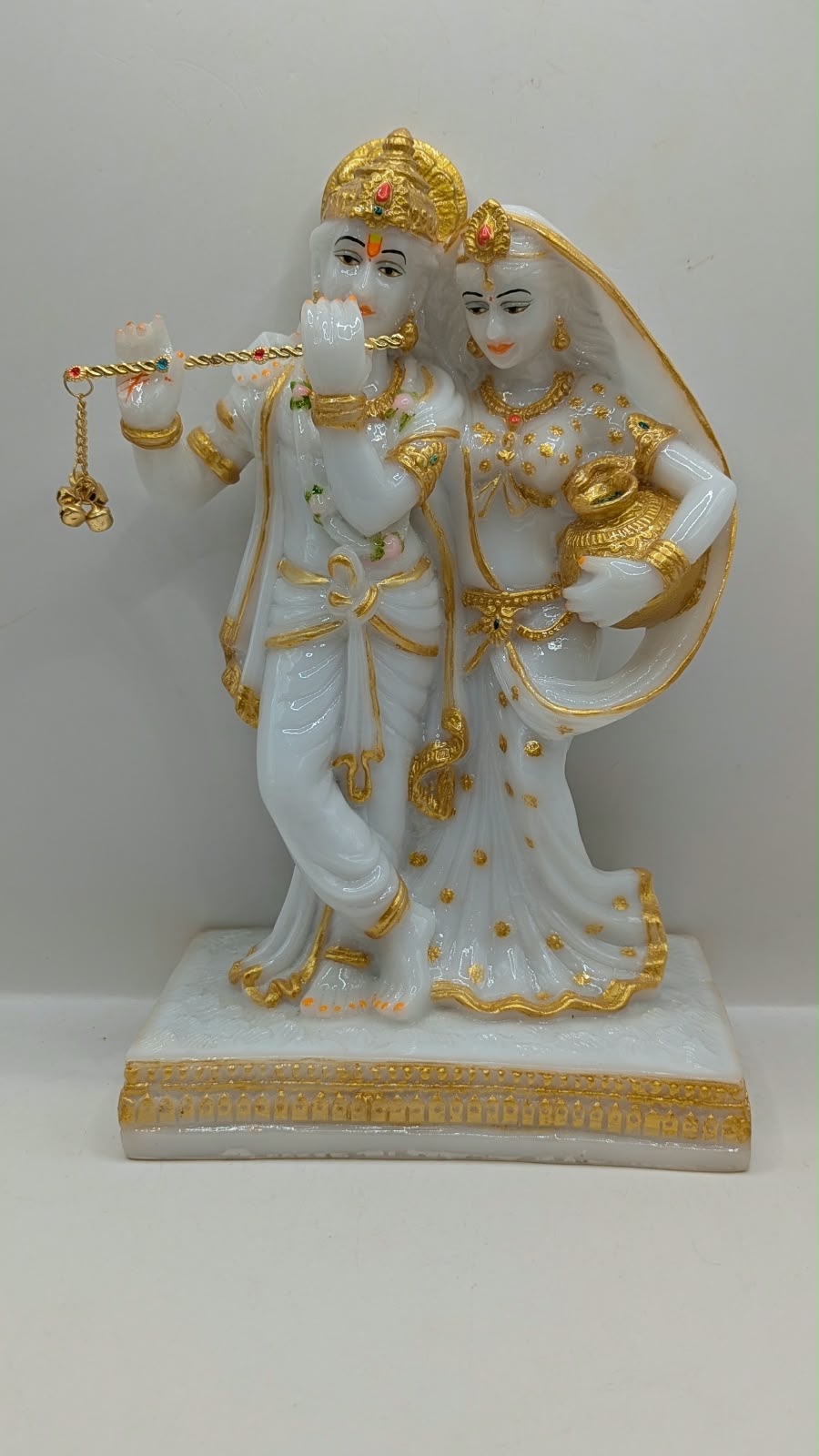 White and gold Radha Krishna statue with flute, front view