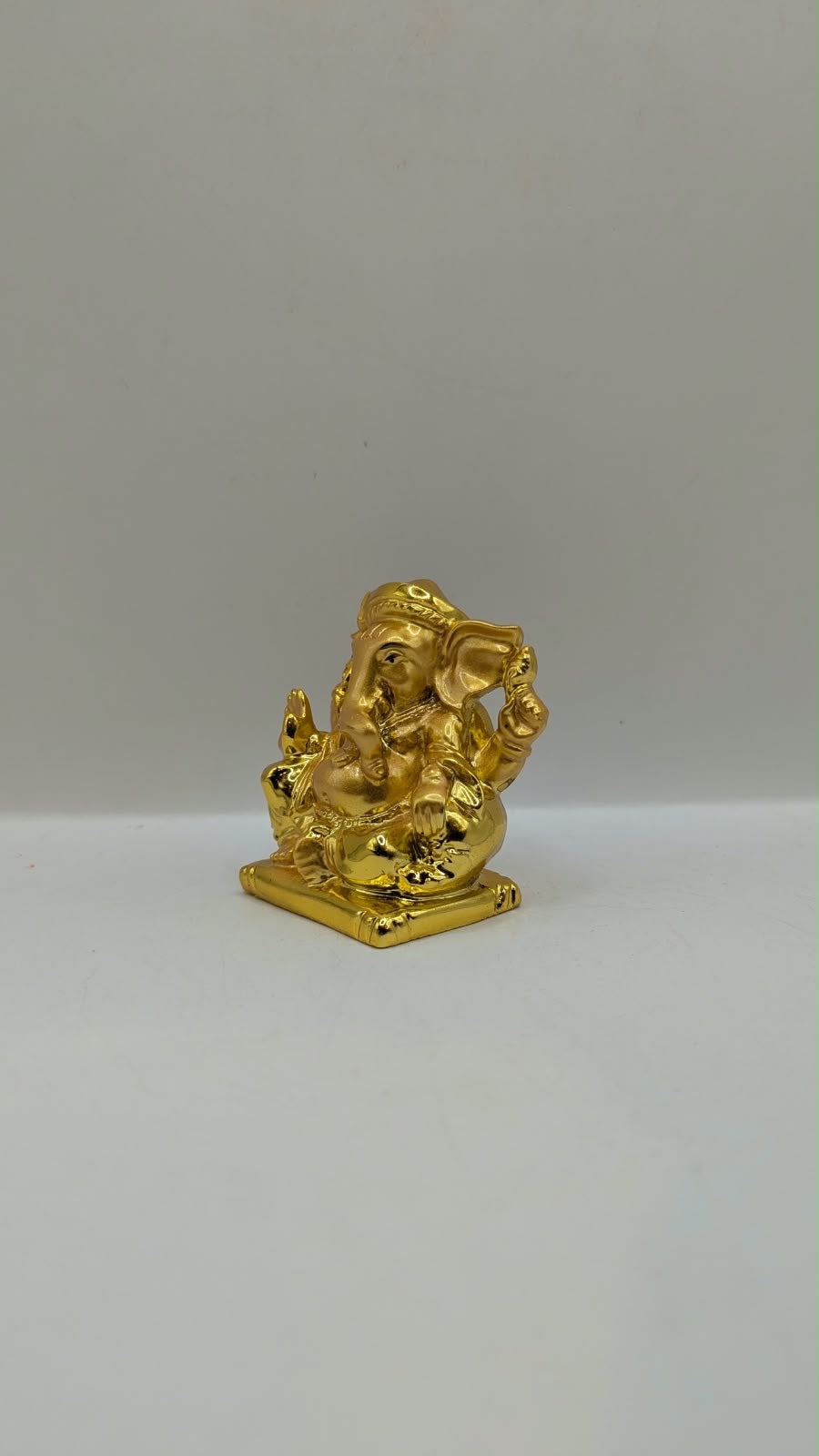 Small gold Ganesh statue, other side view