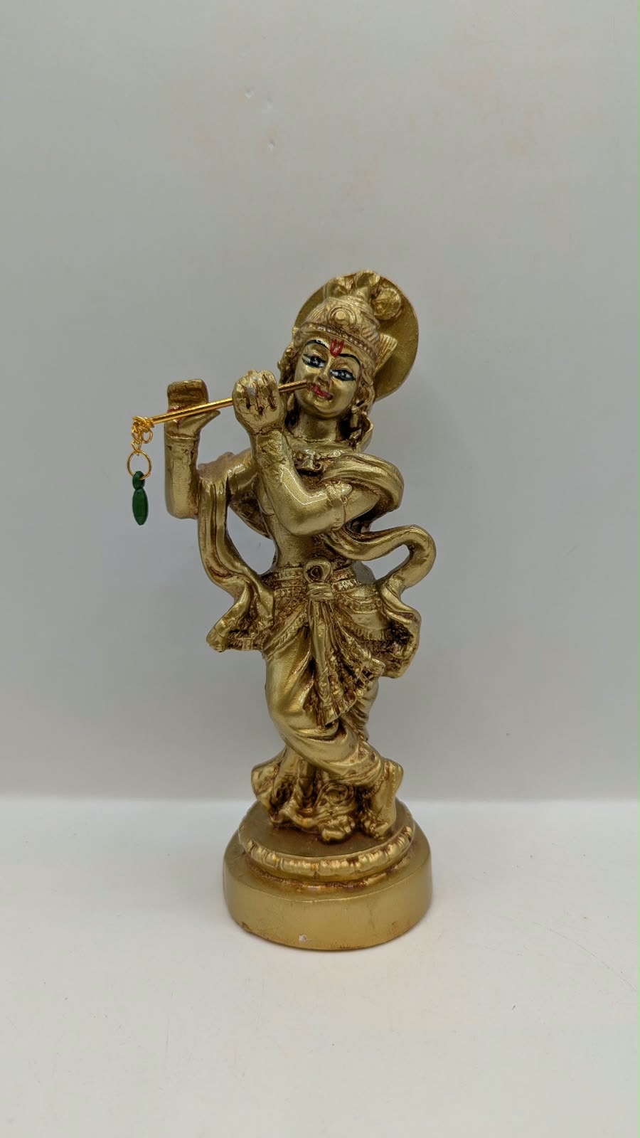 Gold Lord Krishna statue with flute, front view