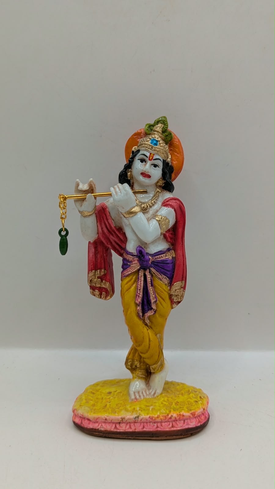Colourful Lord Krishna statue with flute, front view