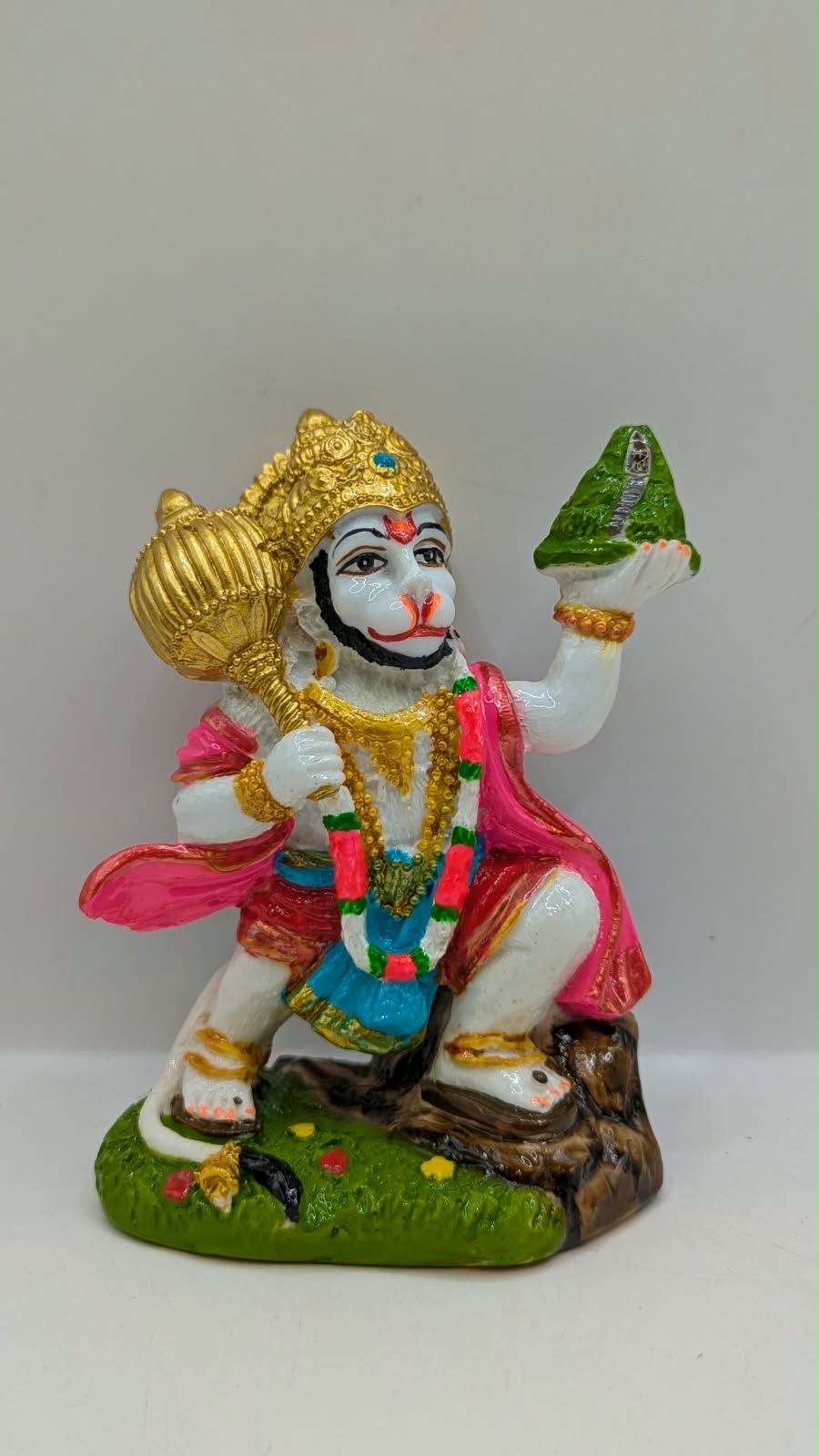Colourful Hanuman statue with mountain and mace, front view