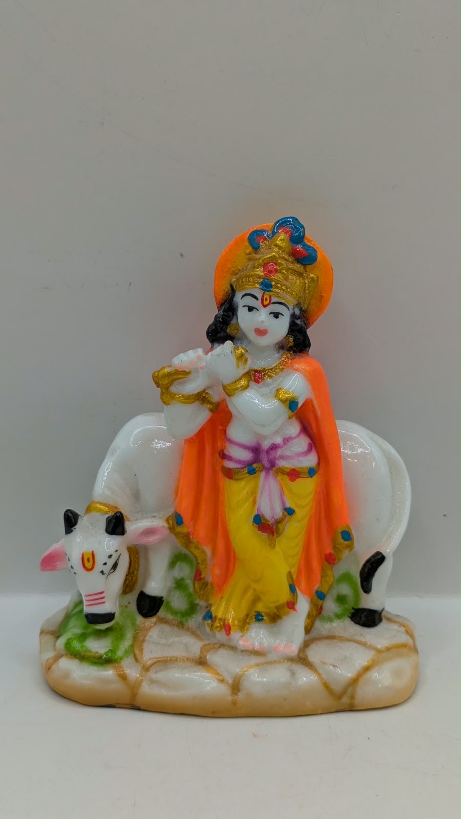 Lord Krishna statue standing with cow, front view