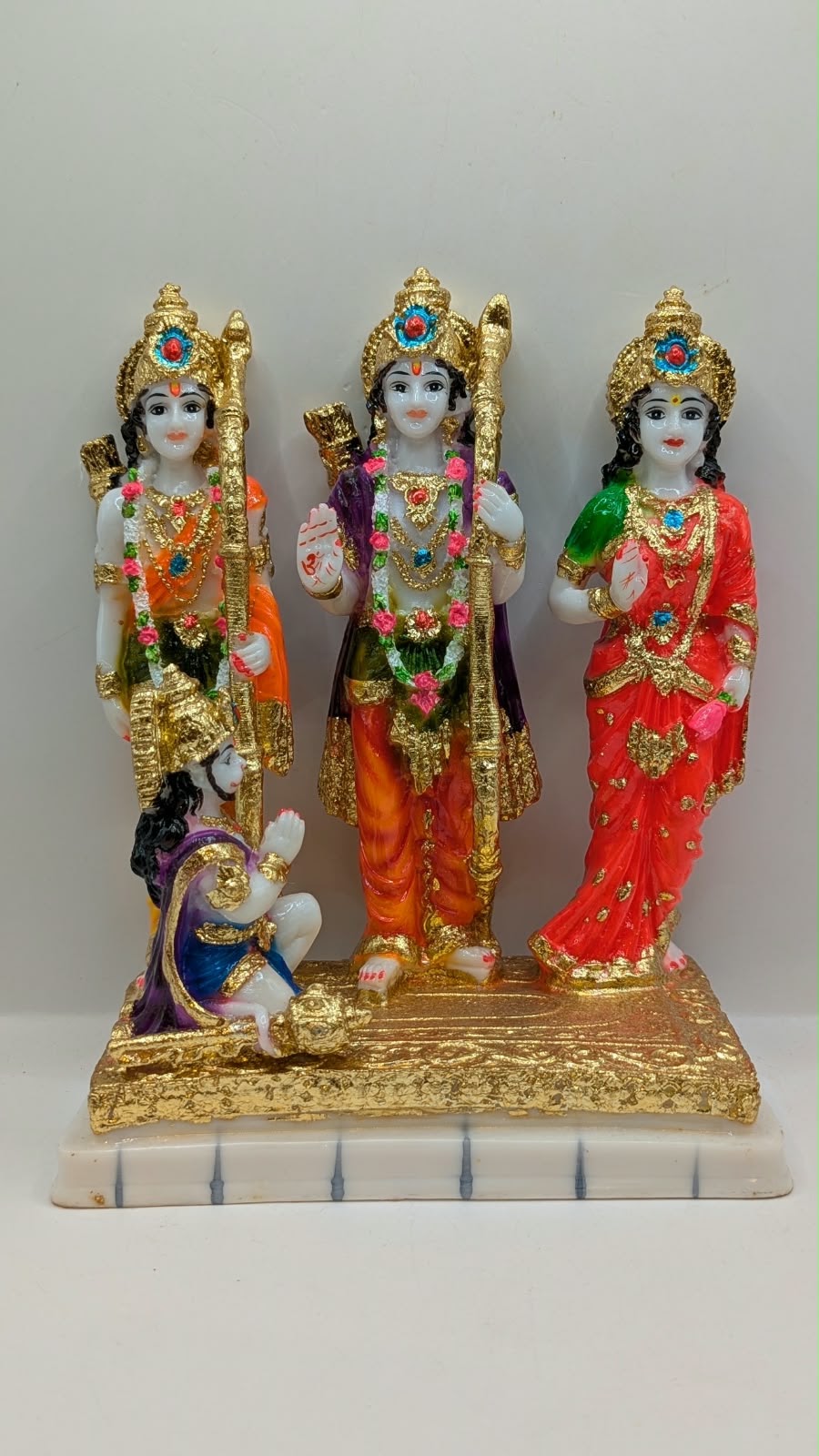 Colourful Ram Darbar statue with gold base, side view