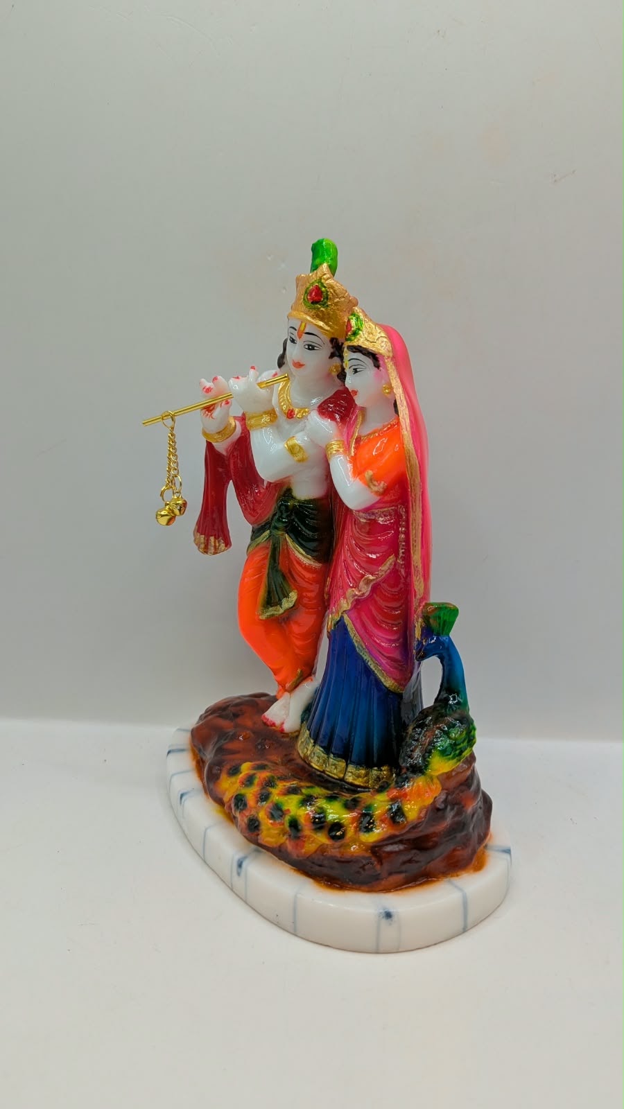 Colourful Radha Krishna statue with peacock, other side view