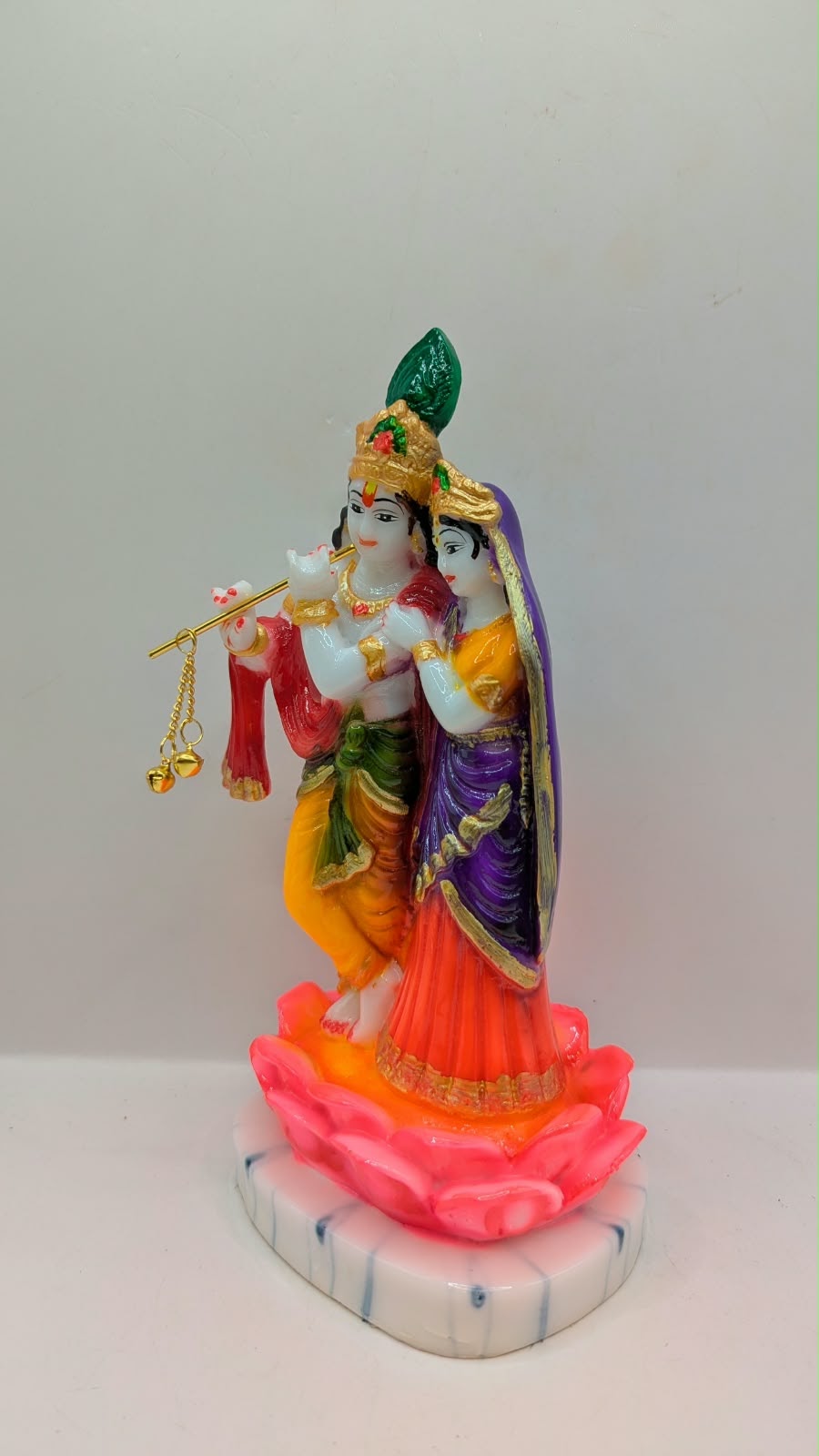Colourful Radha Krishna statue on pink lotus, other side view