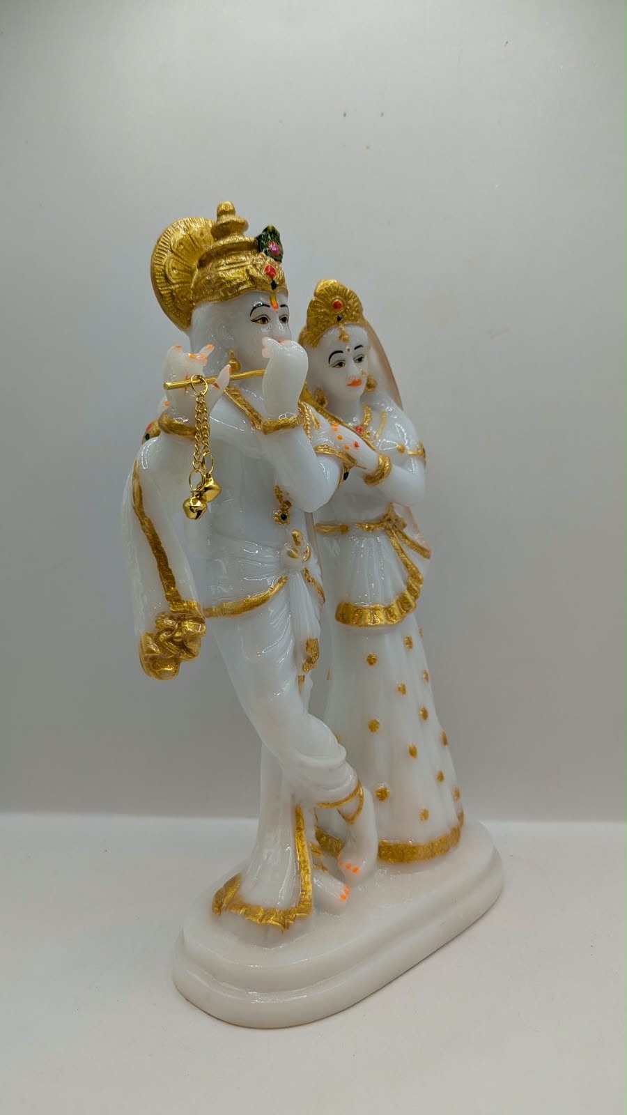 Tall white and gold Radha Krishna statue, side view