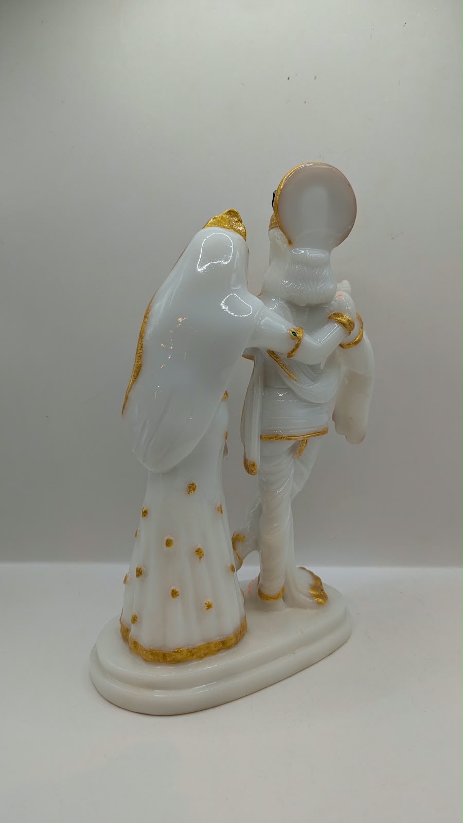 Tall white and gold Radha Krishna statue, back view