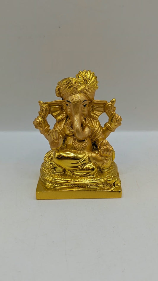 Gold Ganesh statue wearing a turban, front view