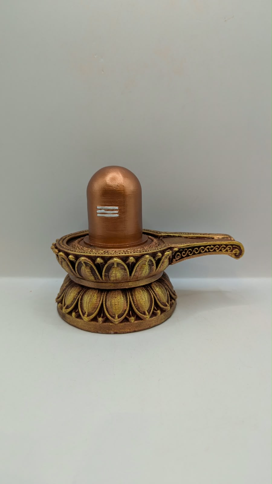 Copper and gold Shivling statue, front view