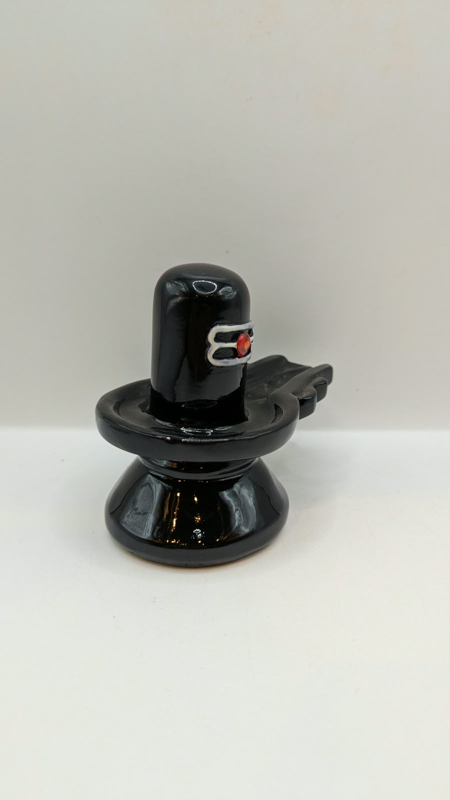Glossy black Shivling statue, side view