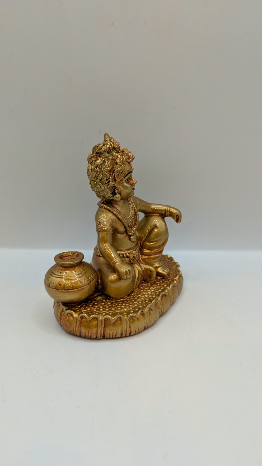 Gold Laddu Gopal baby Krishna statue, side view