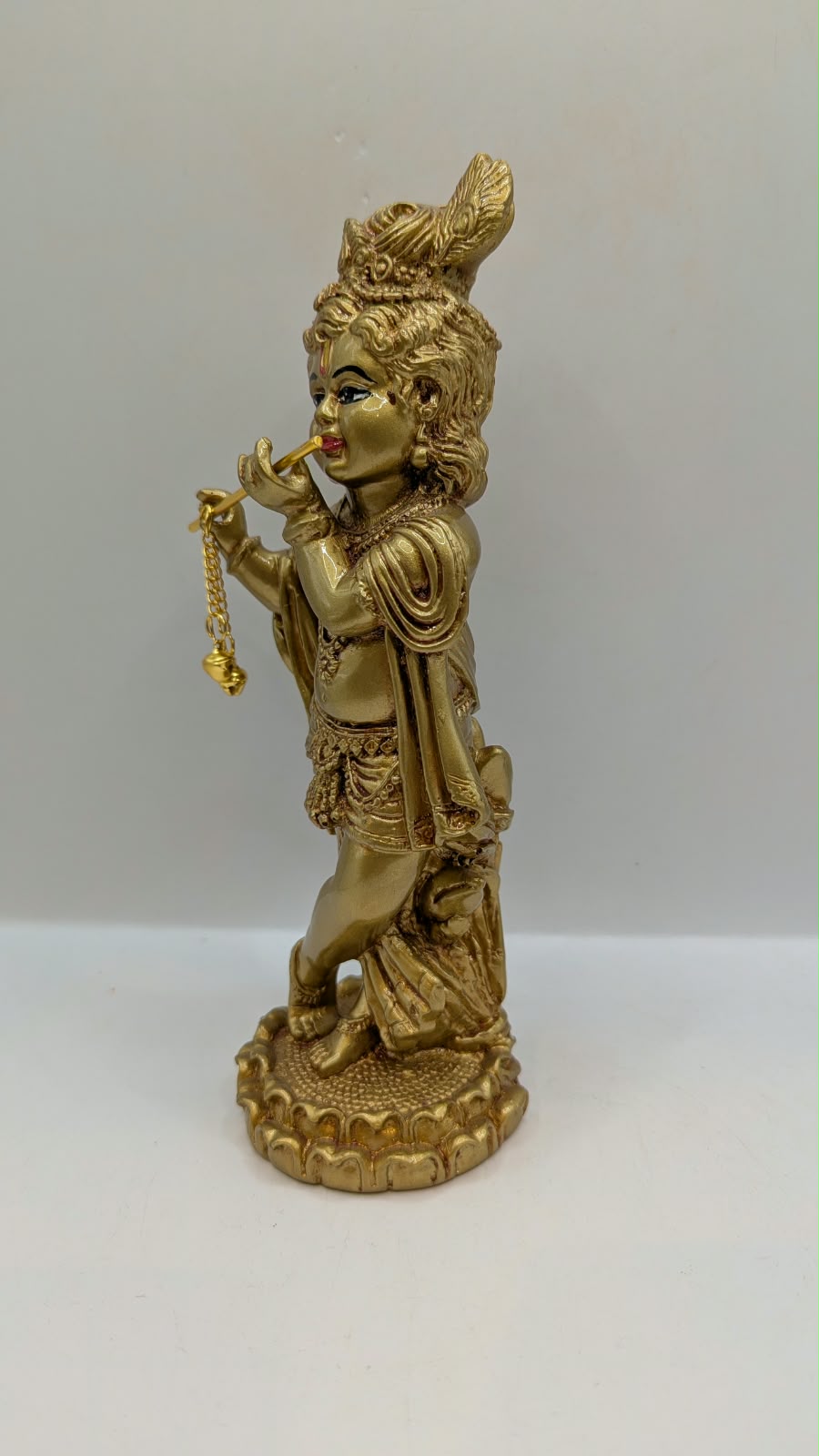 Gold standing Krishna statue with flute, other side view