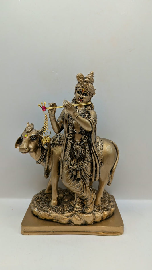 Antique gold Krishna with cow statue, front view