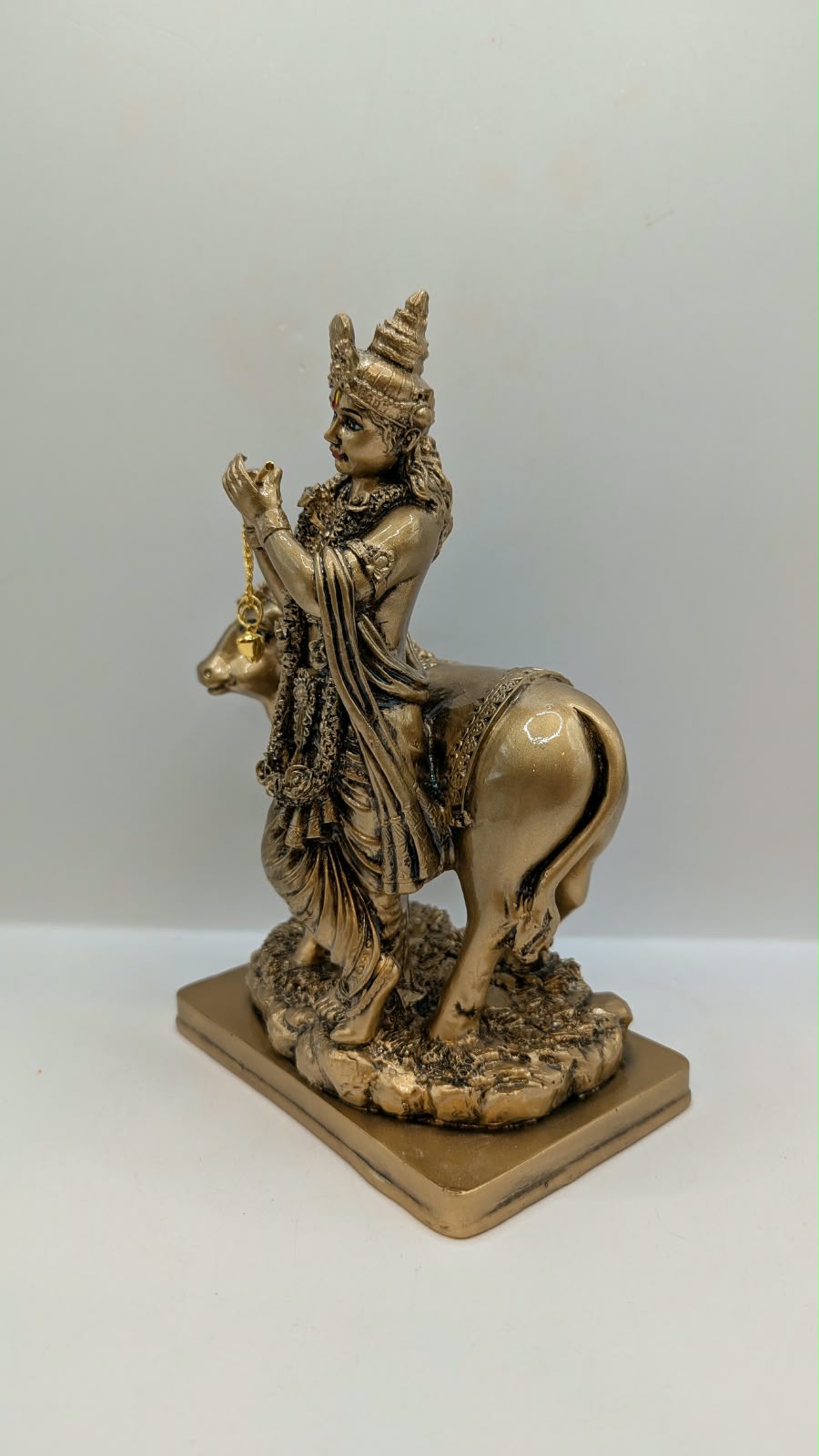 Antique gold Krishna with cow statue, other side view