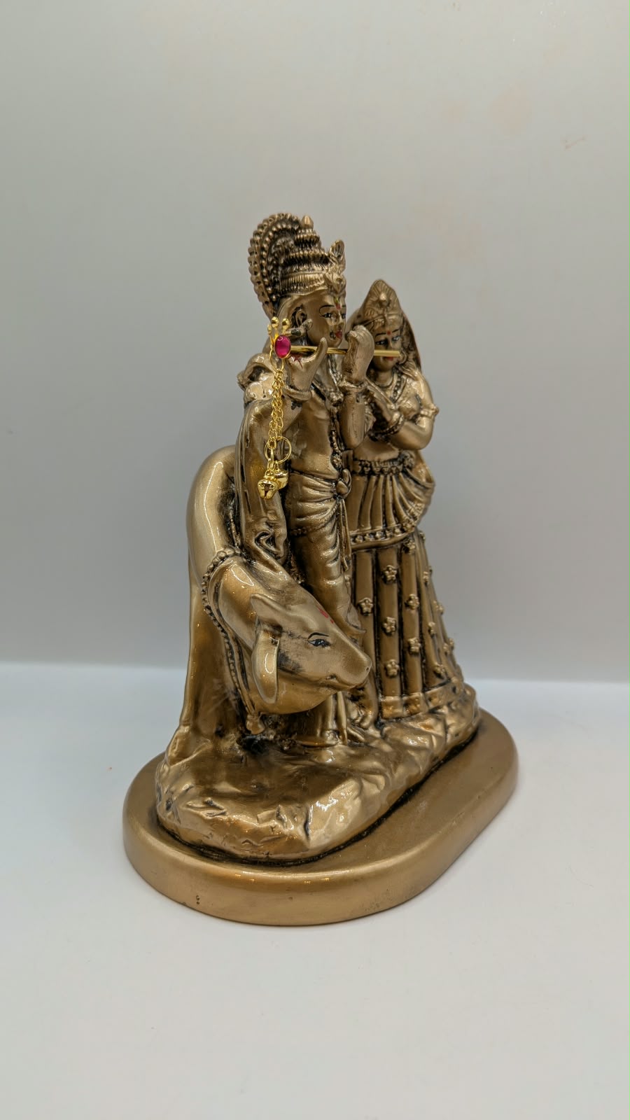 Antique gold Radha Krishna with cow statue, side view