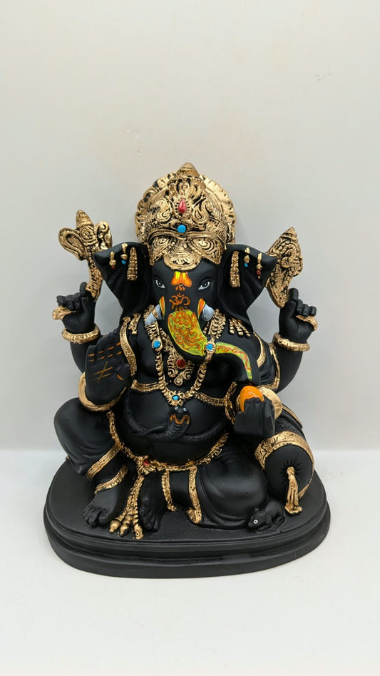Black and gold Ganesh statue with crown, front view