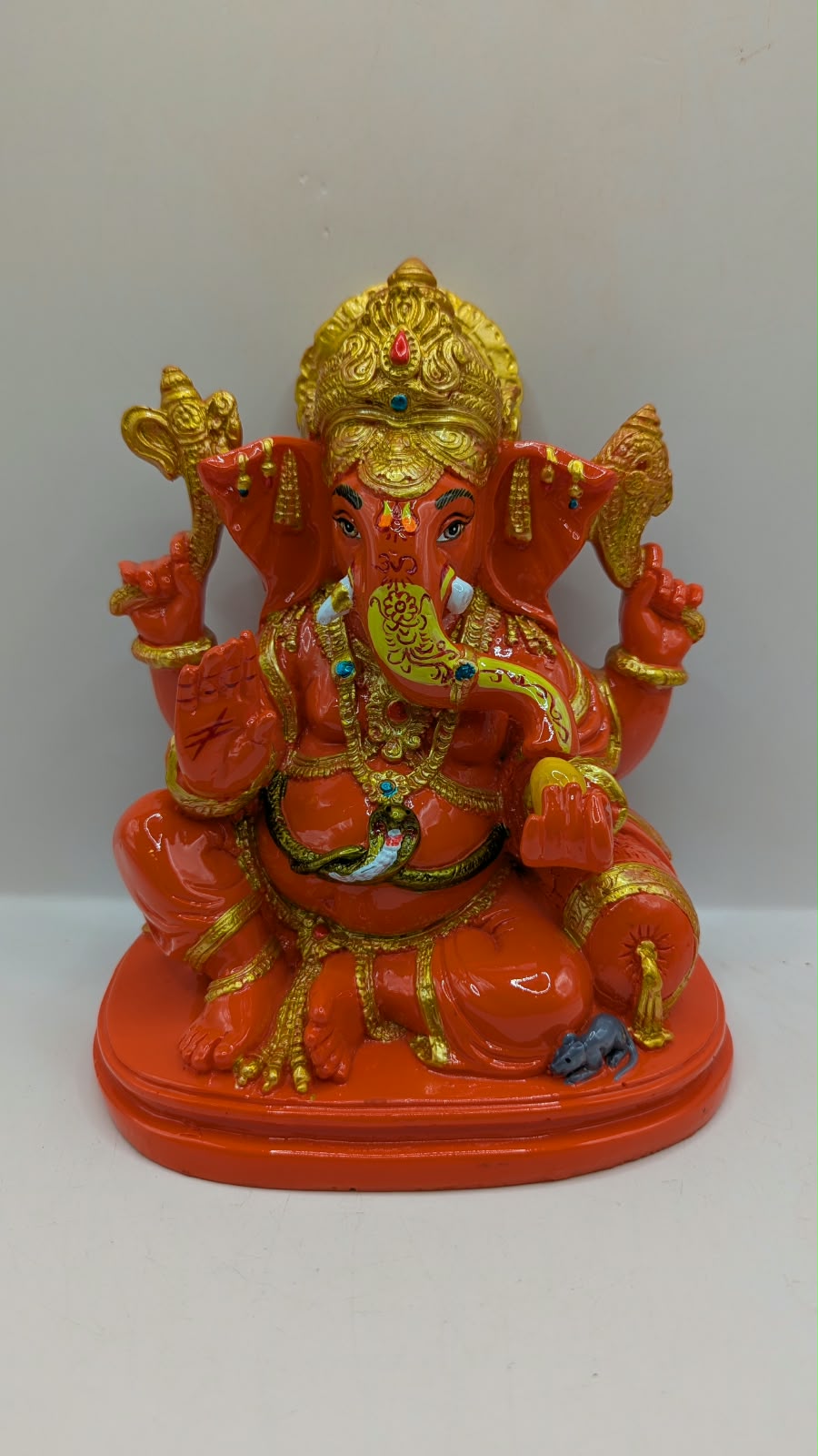 Orange and gold Ganesh statue, front view