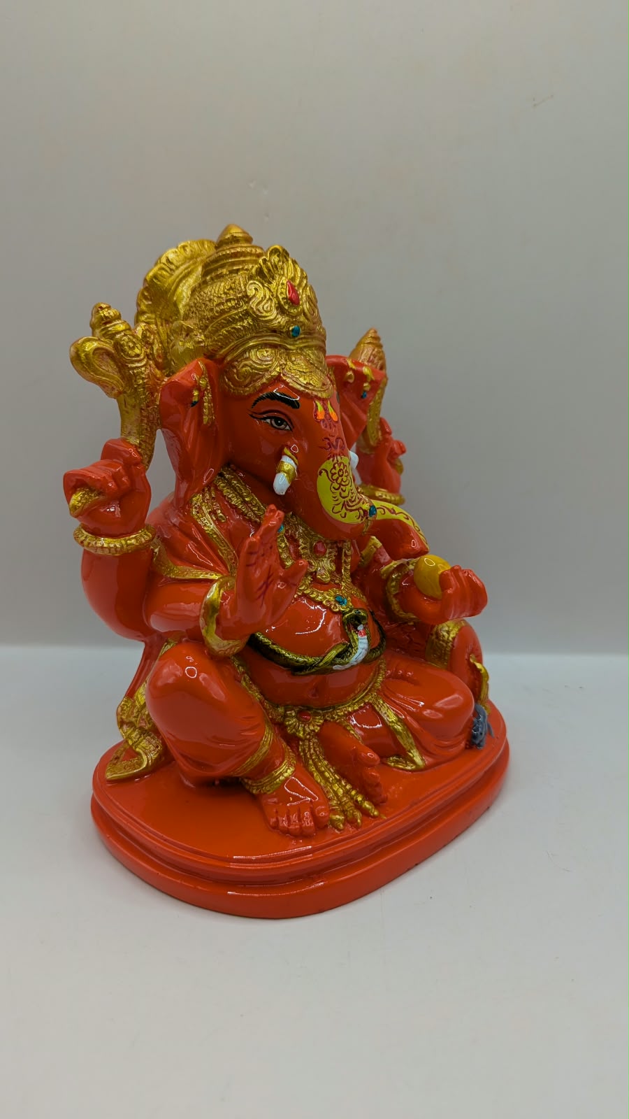 Orange and gold Ganesh statue, side view