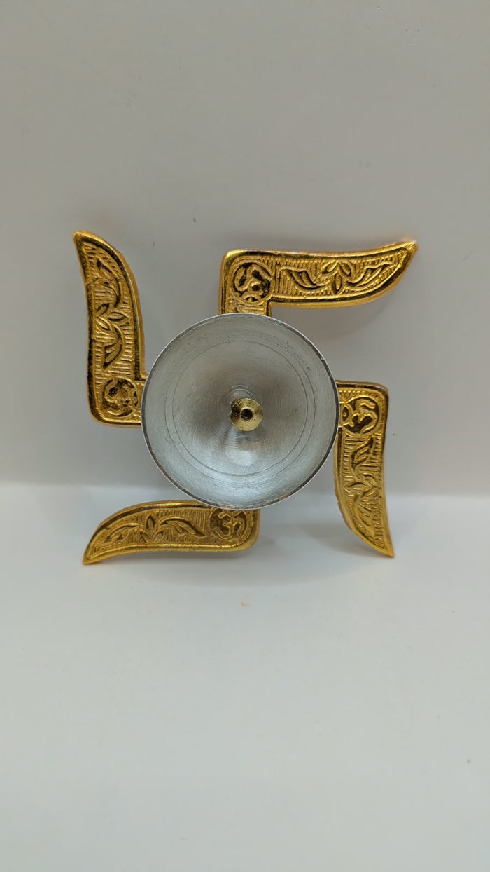 Gold and silver swastik diya, top view