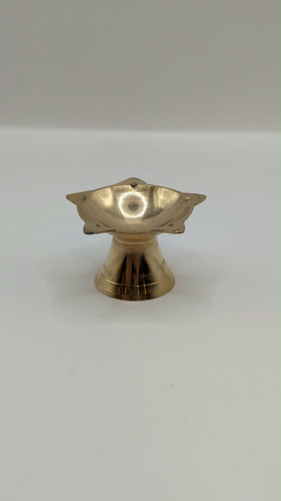 Small metal star diya on stand, front view