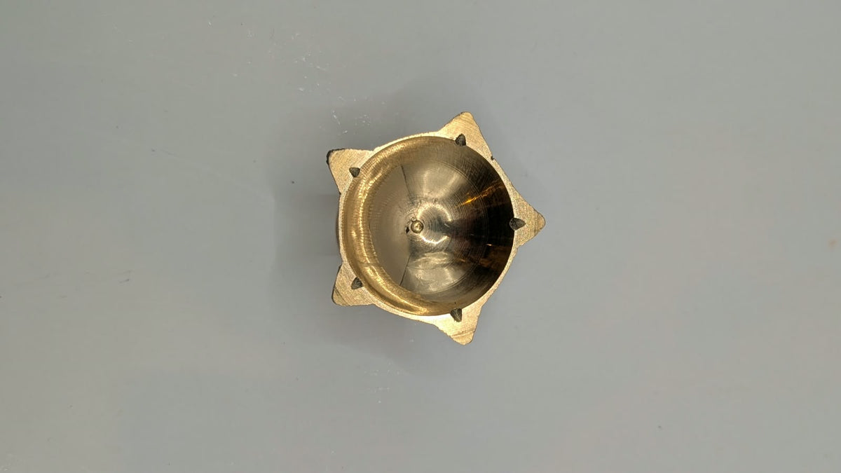 Small metal star diya on stand, top view