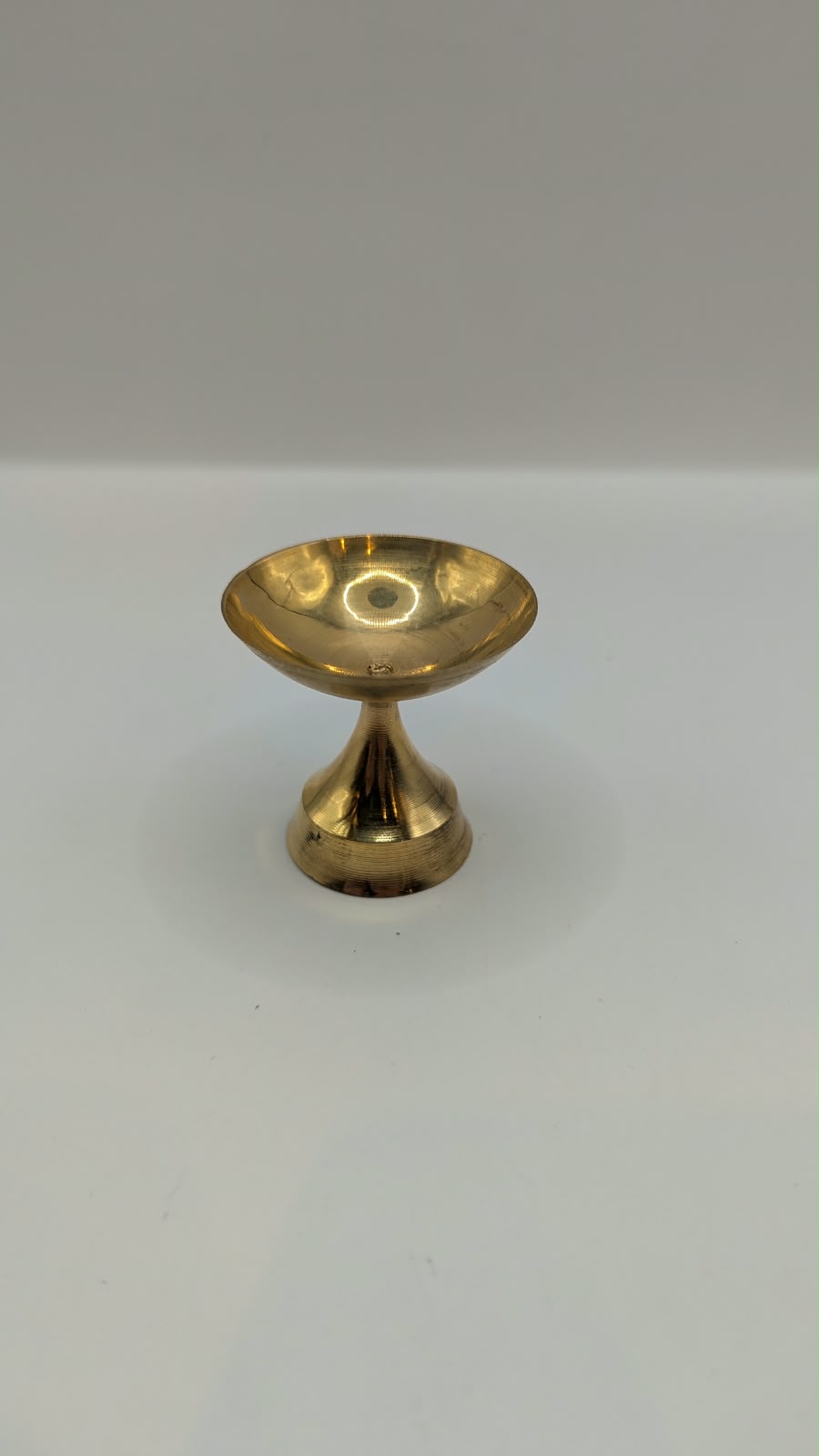 Metal diya on stand, top view