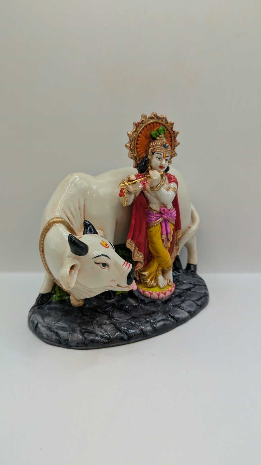 Krishna with white cow statue, side view